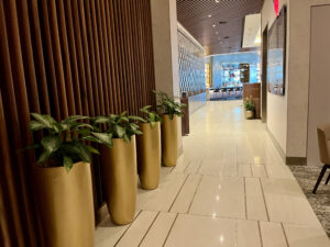 hallway of plants in Delta One Lounge LAX