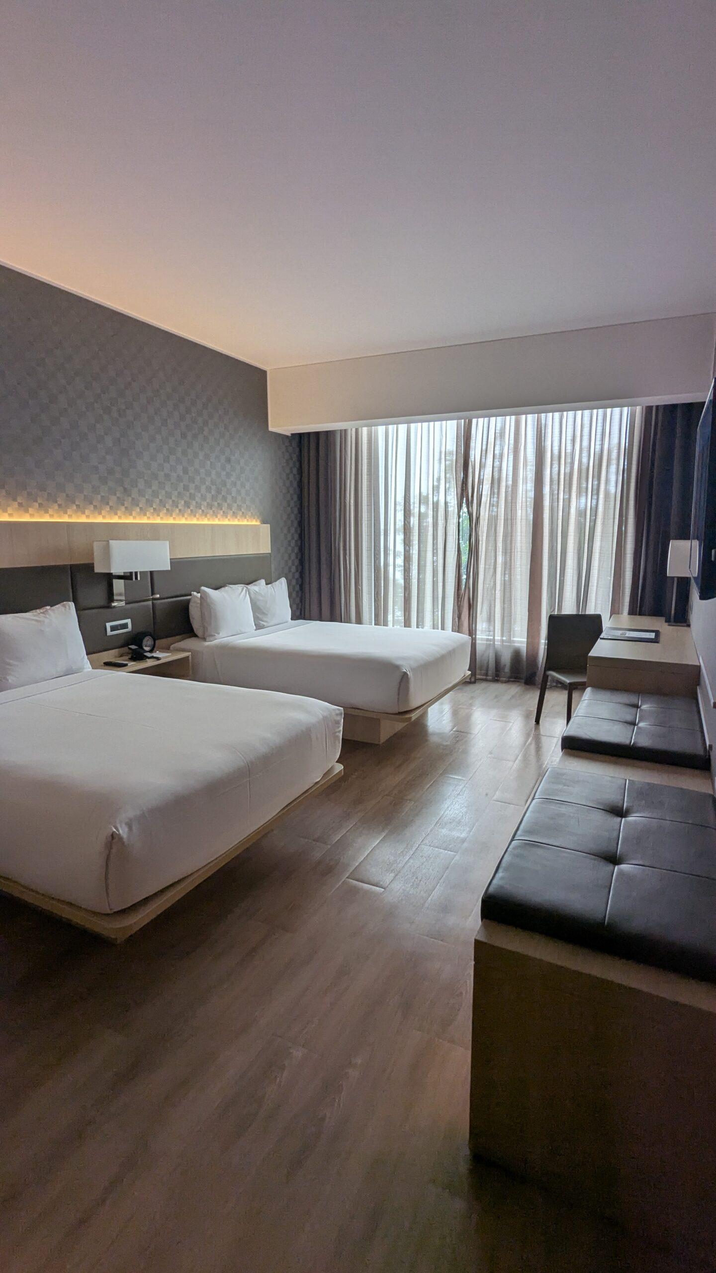 Two queen sized beds in a hotel room at the AC Hotel Lima Miraflores. 