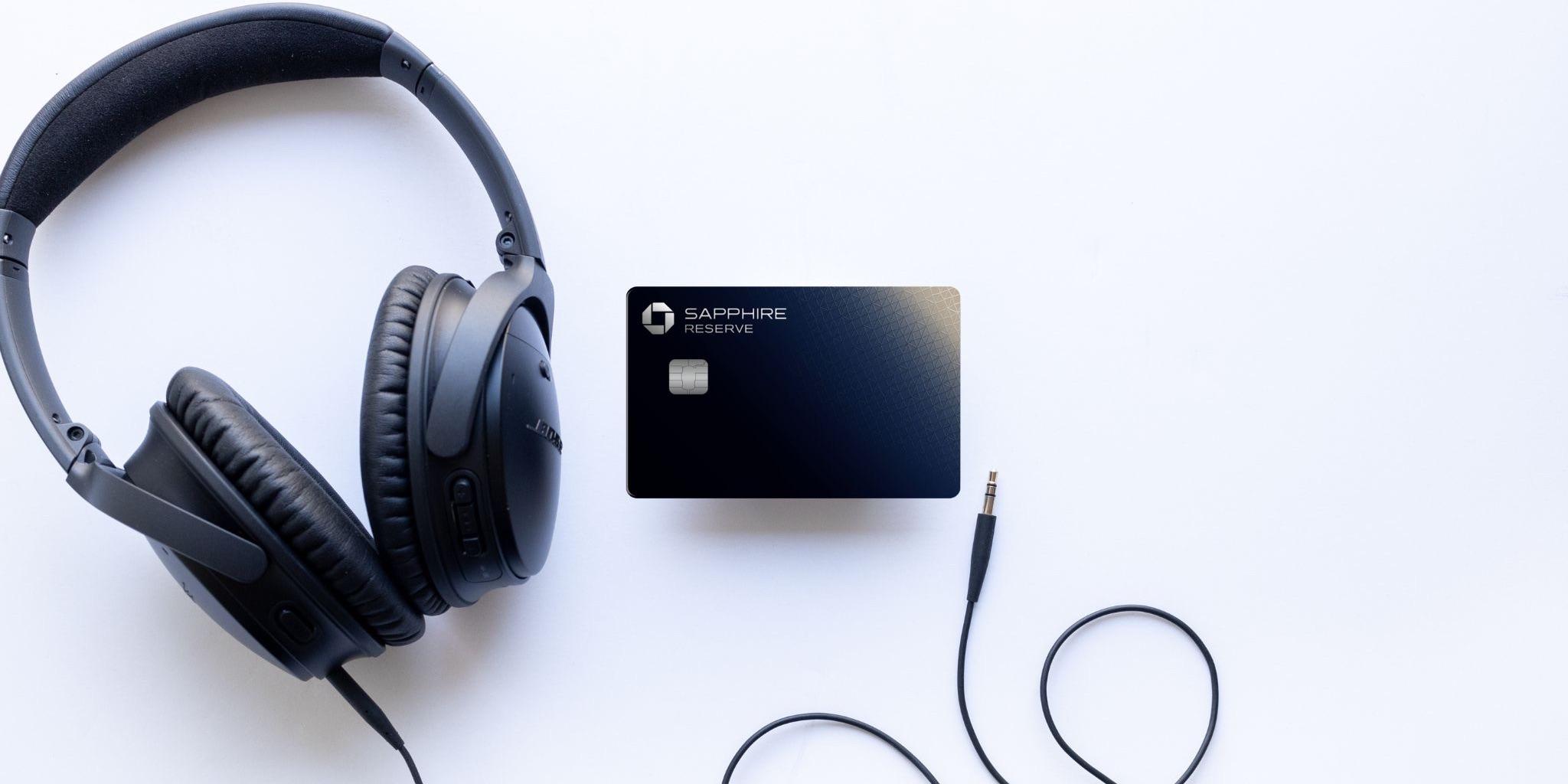 Chase Sapphire Reserve Card with a pair of headphones on a white background.