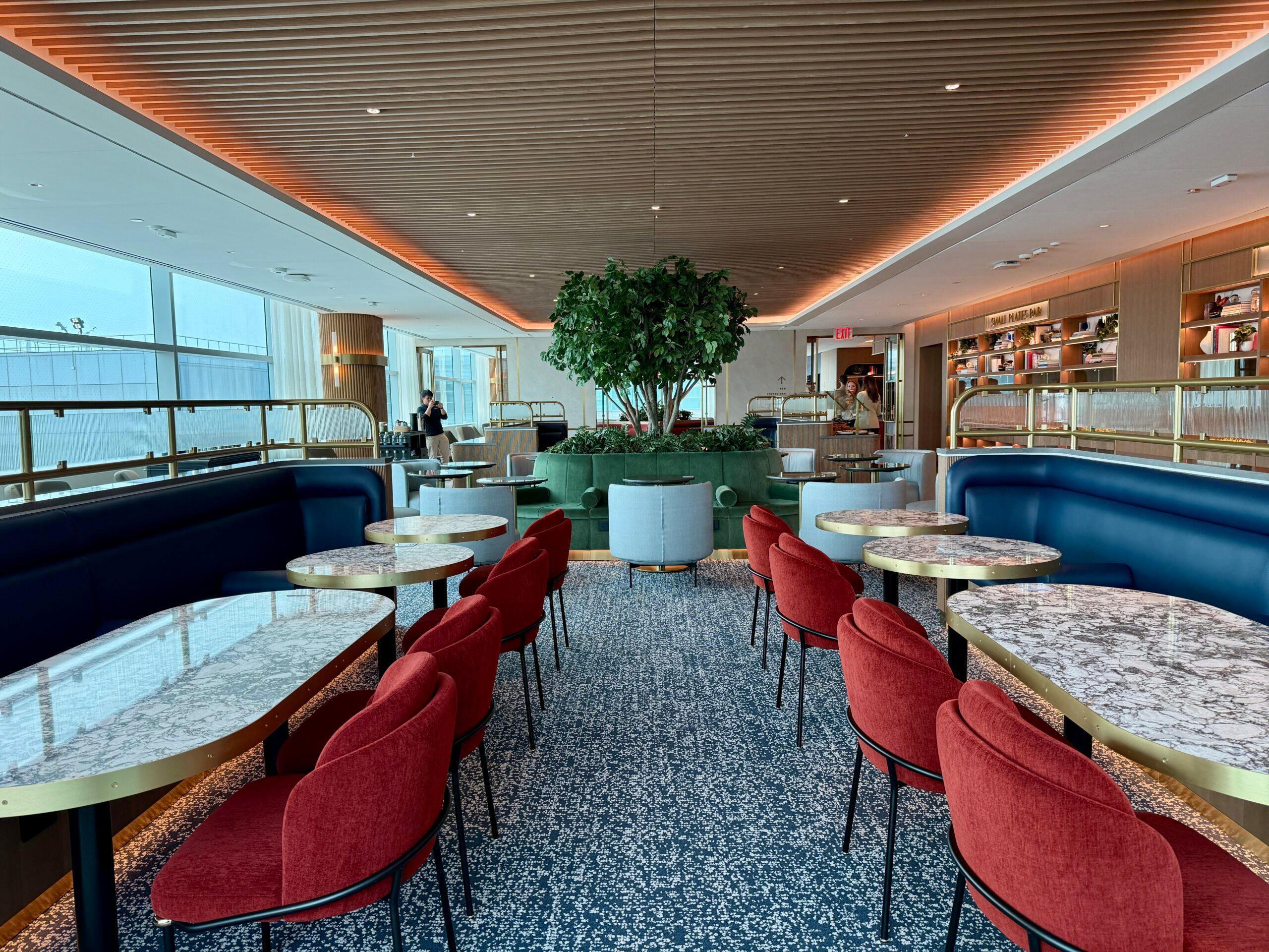 red chairs at marble tables and blue benches with wood ceiling overhead