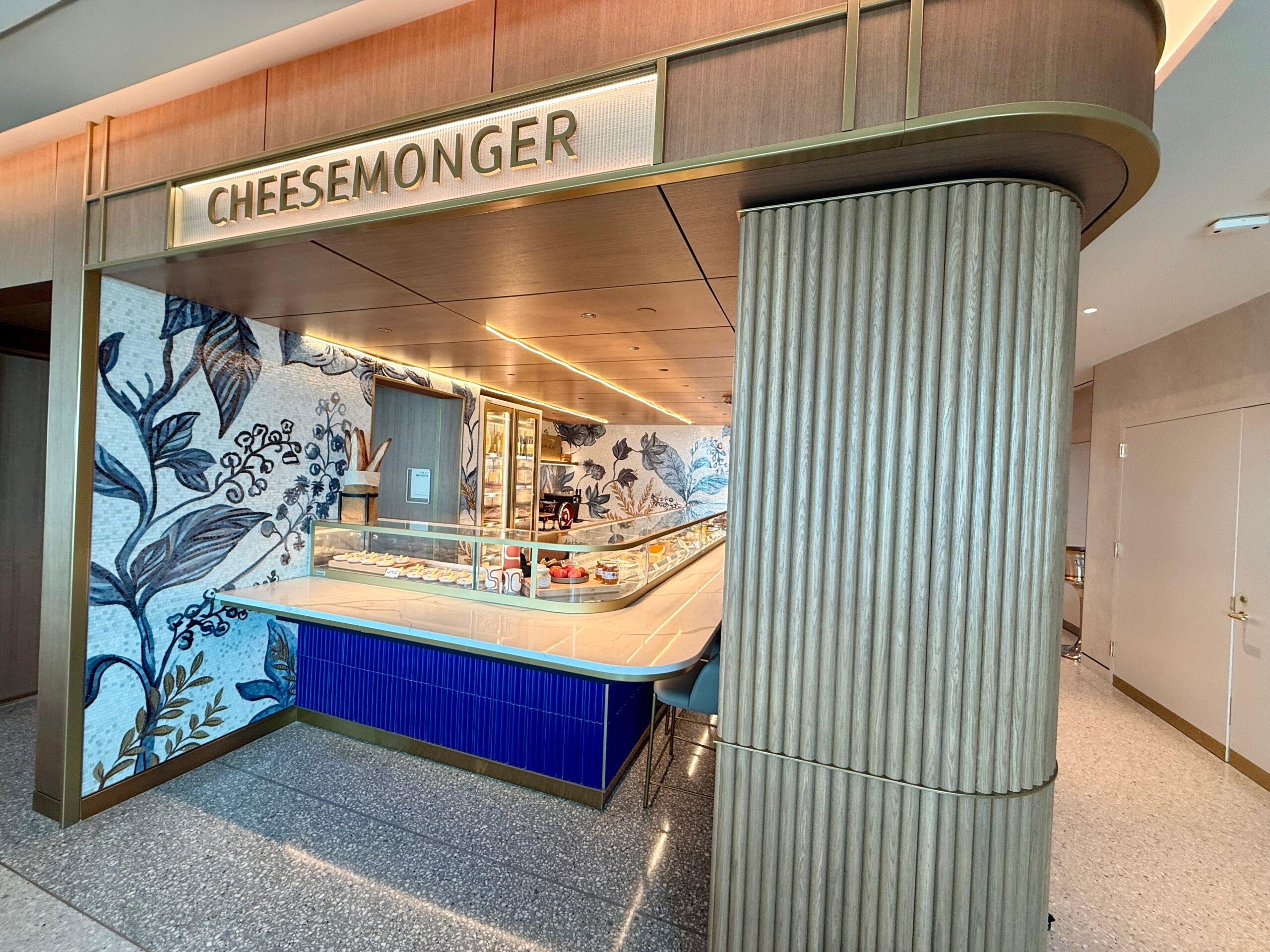 cheesmonger station with a blue counter and tile walls