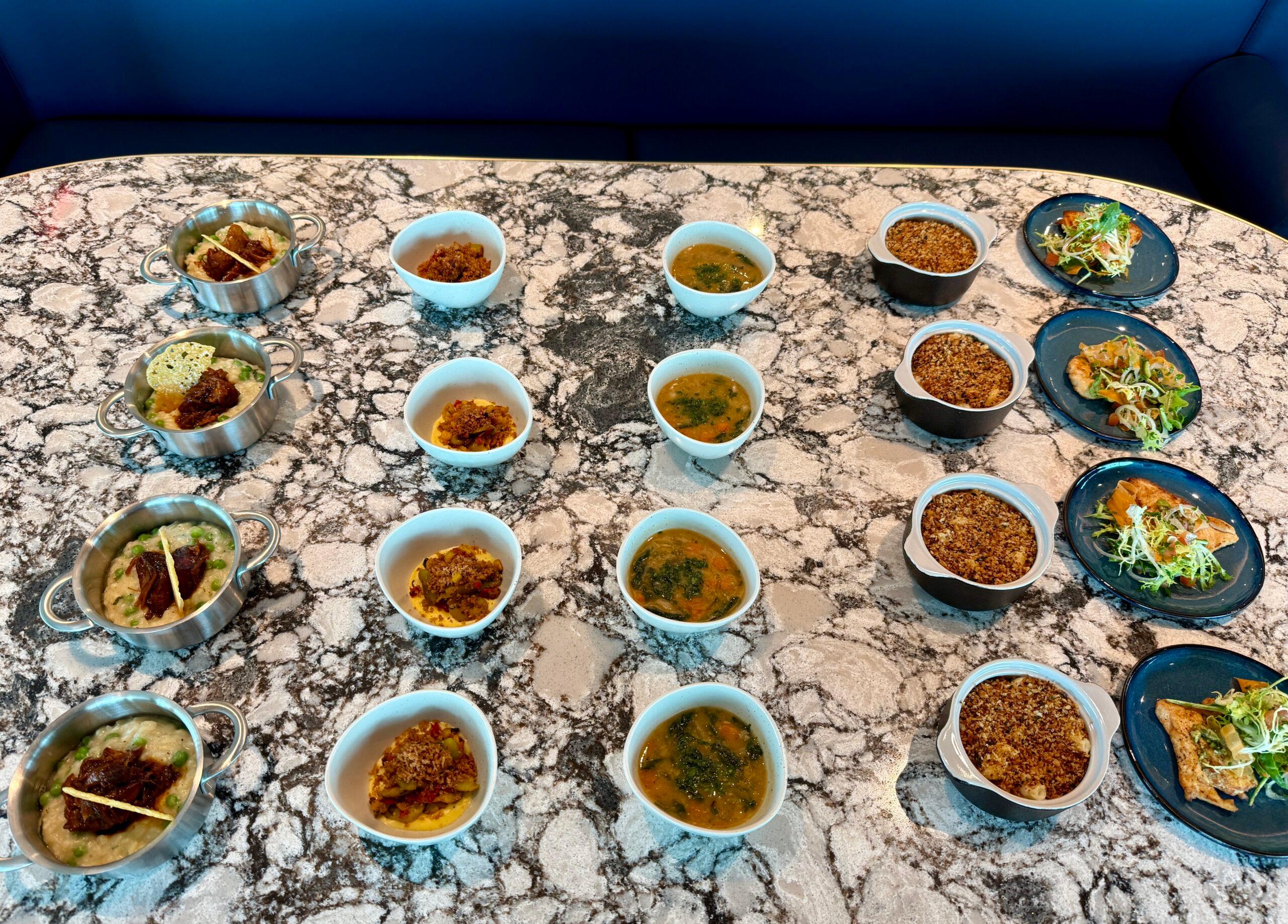 several dishes of food on a black marble table
