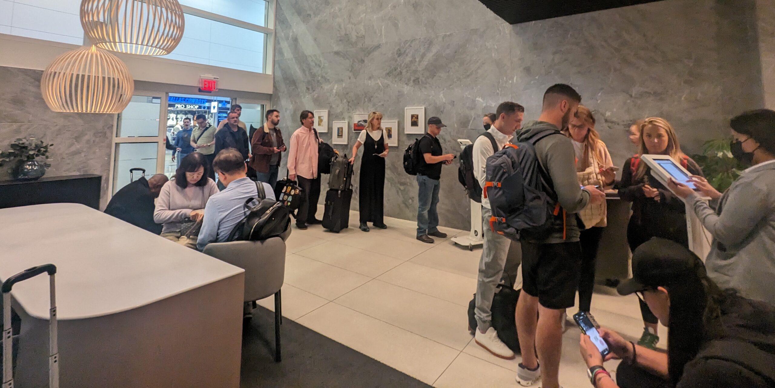 A line of travelers waiting to get into the Capital One Lounge (DFW). 