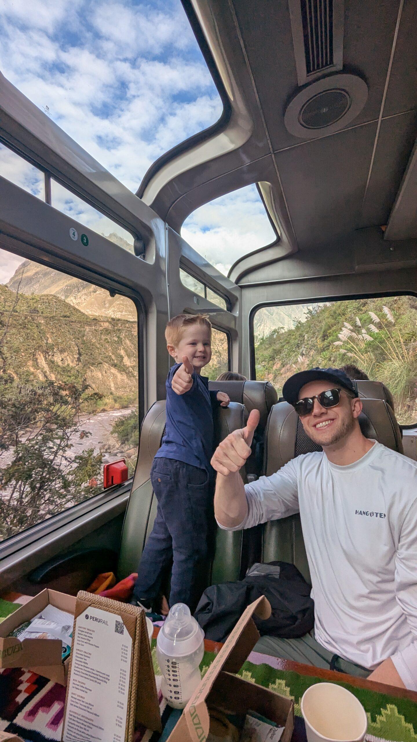 A man and young boy on the Peru Rail train to Machu Picchu.