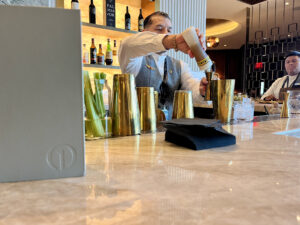 bartender making a cocktail and Delta One Lounge LAX