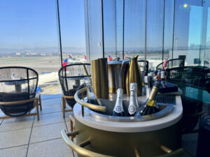 champagne on the patio Delta One lounge LAX