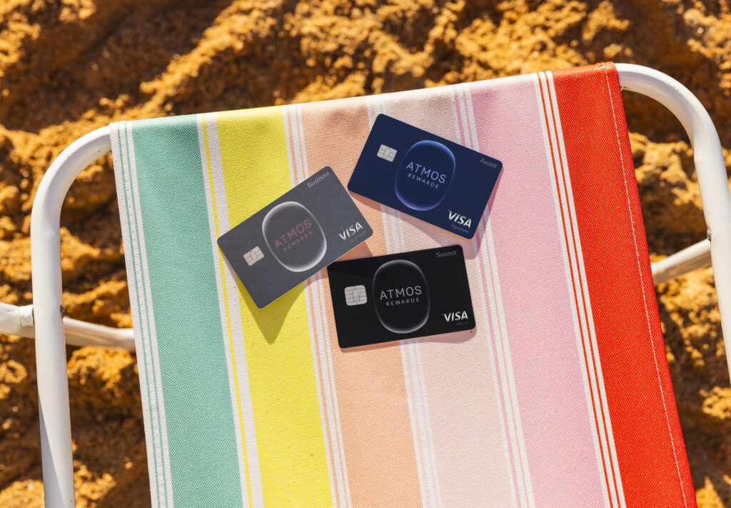 atmos rewards credit cards on a beach chair in the sand