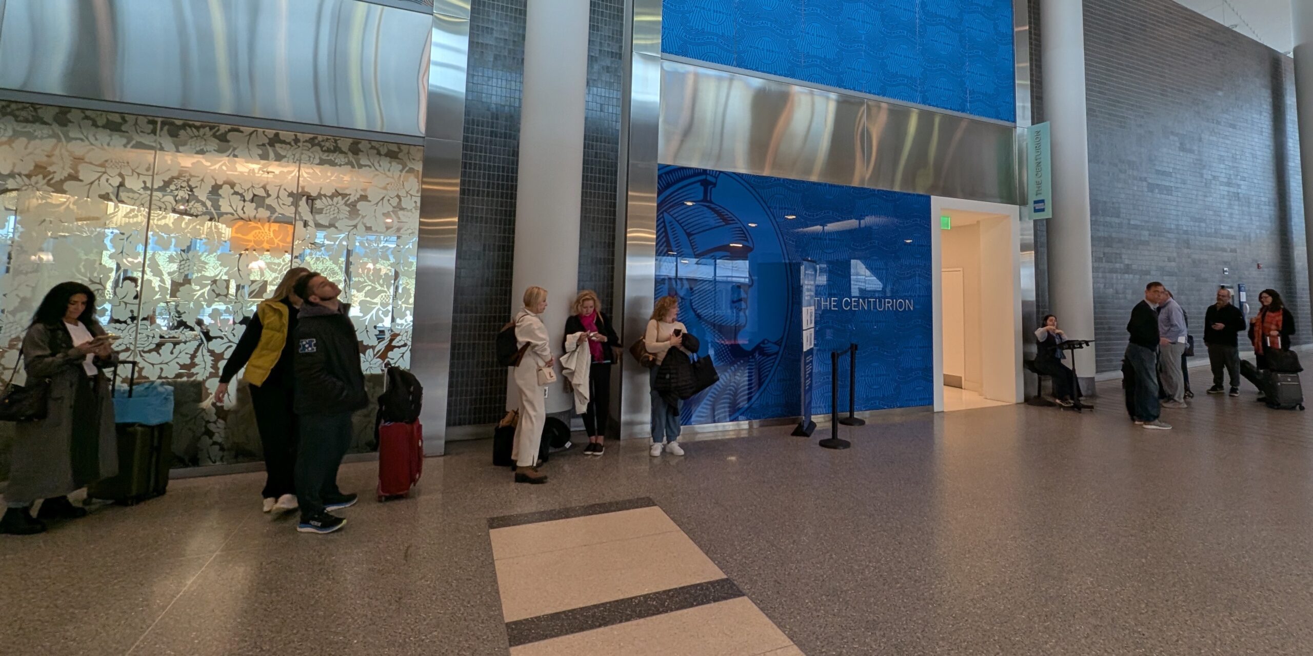 A line of people waiting to get into the Amex Centurion Lounge (PHL)