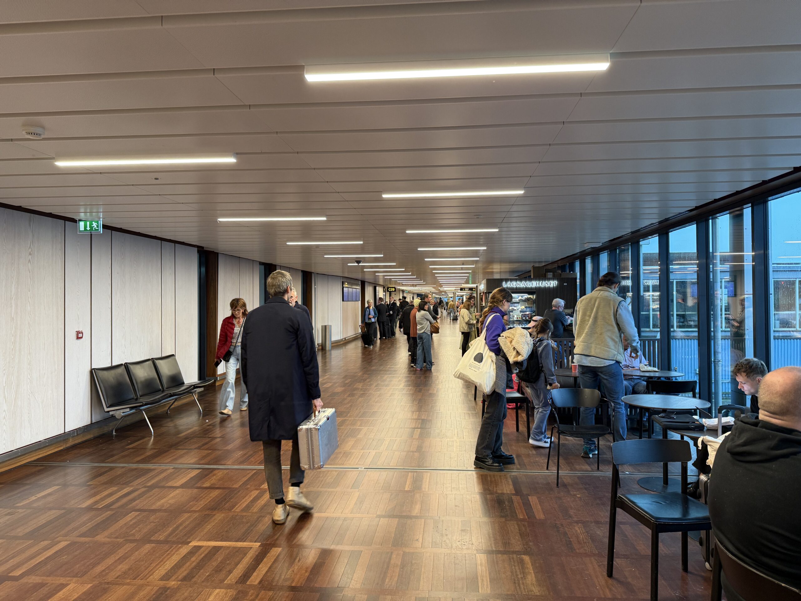 copenhagen airport terminal with passengers sitting and walking