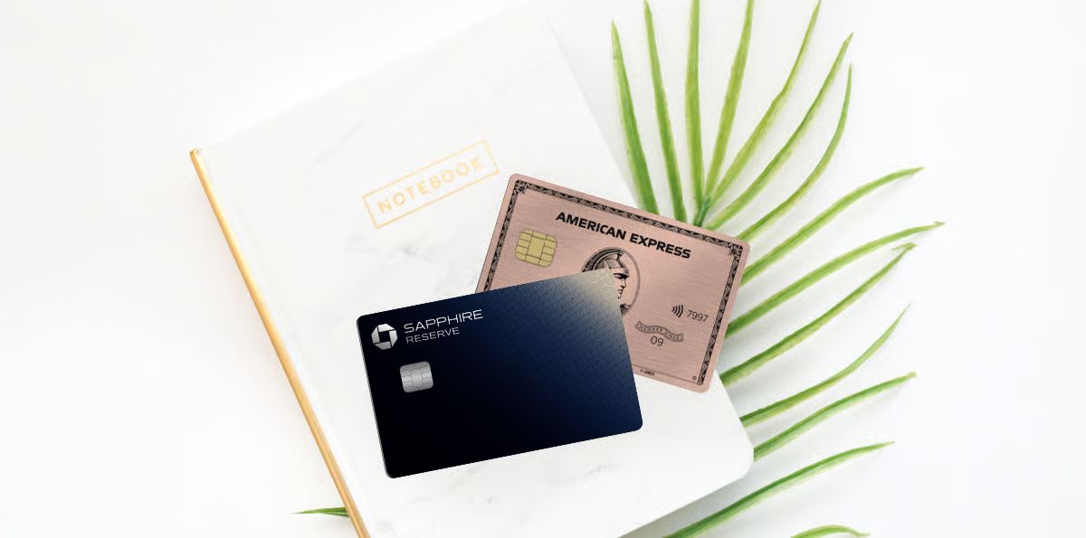 Chase Sapphire Reserve and Amex Gold cards on a notebook with a palm leaf in the background