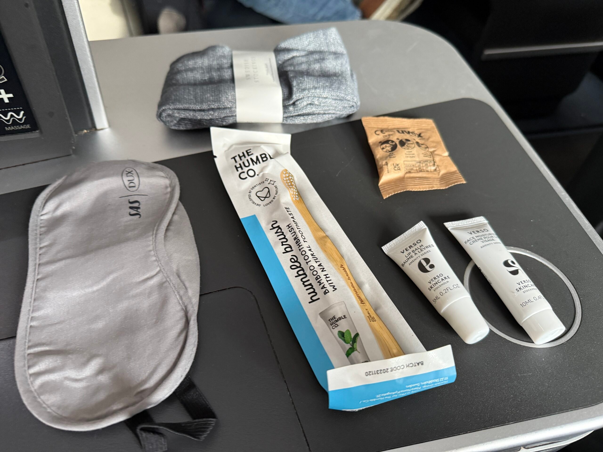 toiletries and amenities laid out on a black storage table