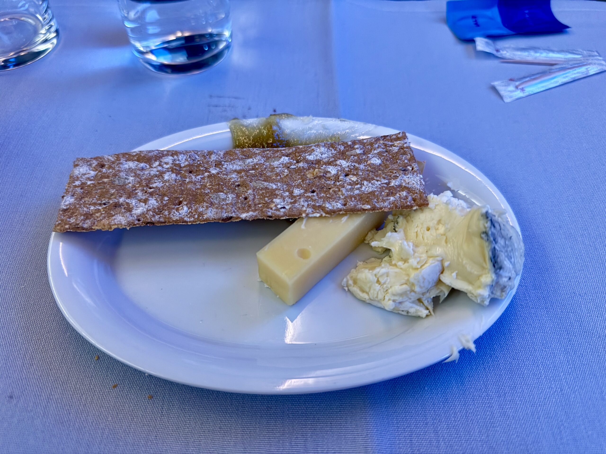 plate of two cheeses with marmalade and a cracker