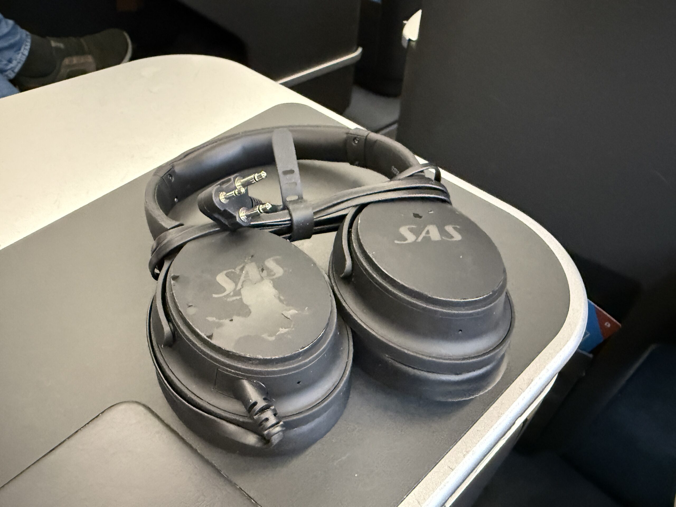 headphones with cord wrapped around sitting on table