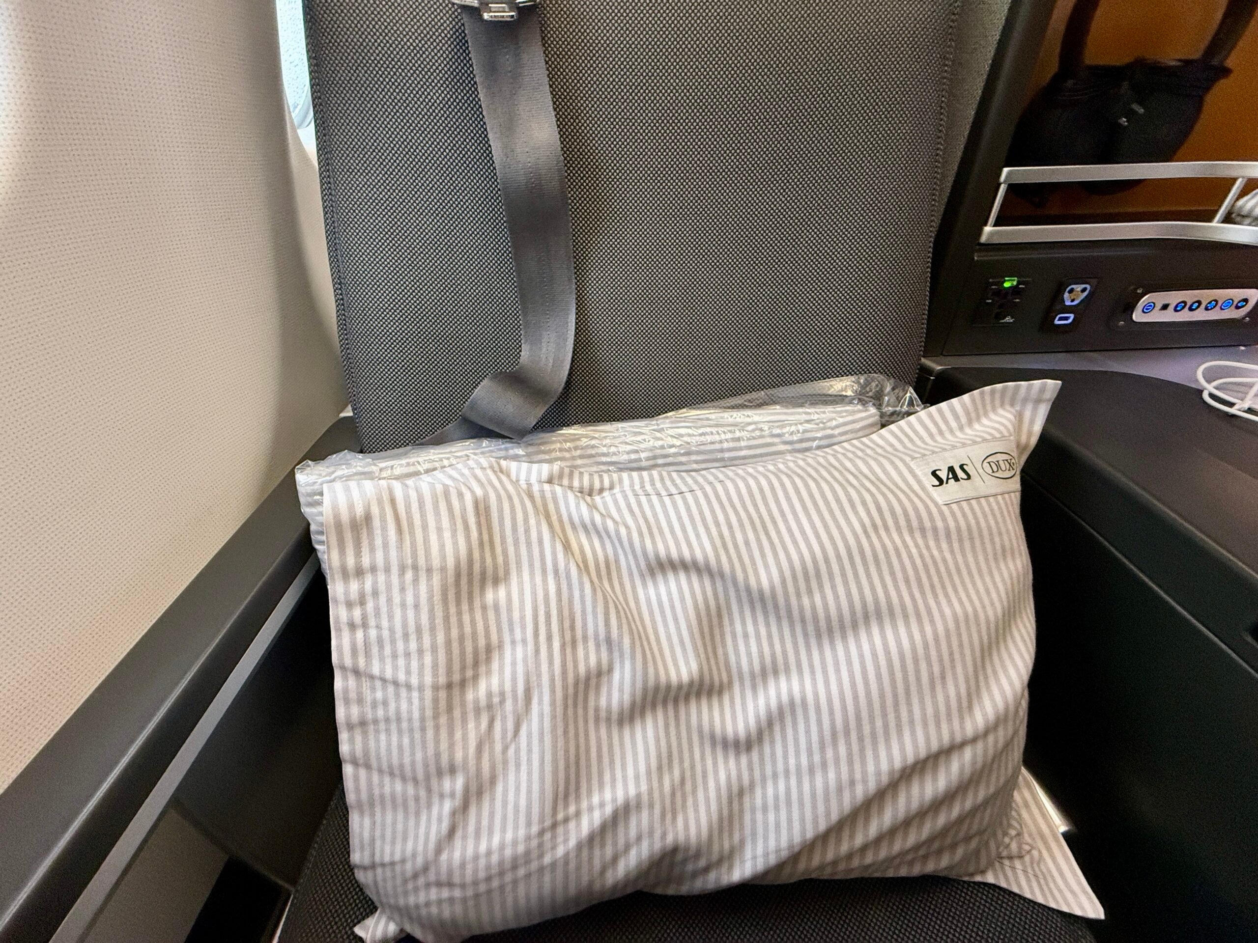 pillow and duvet sitting on plane seat