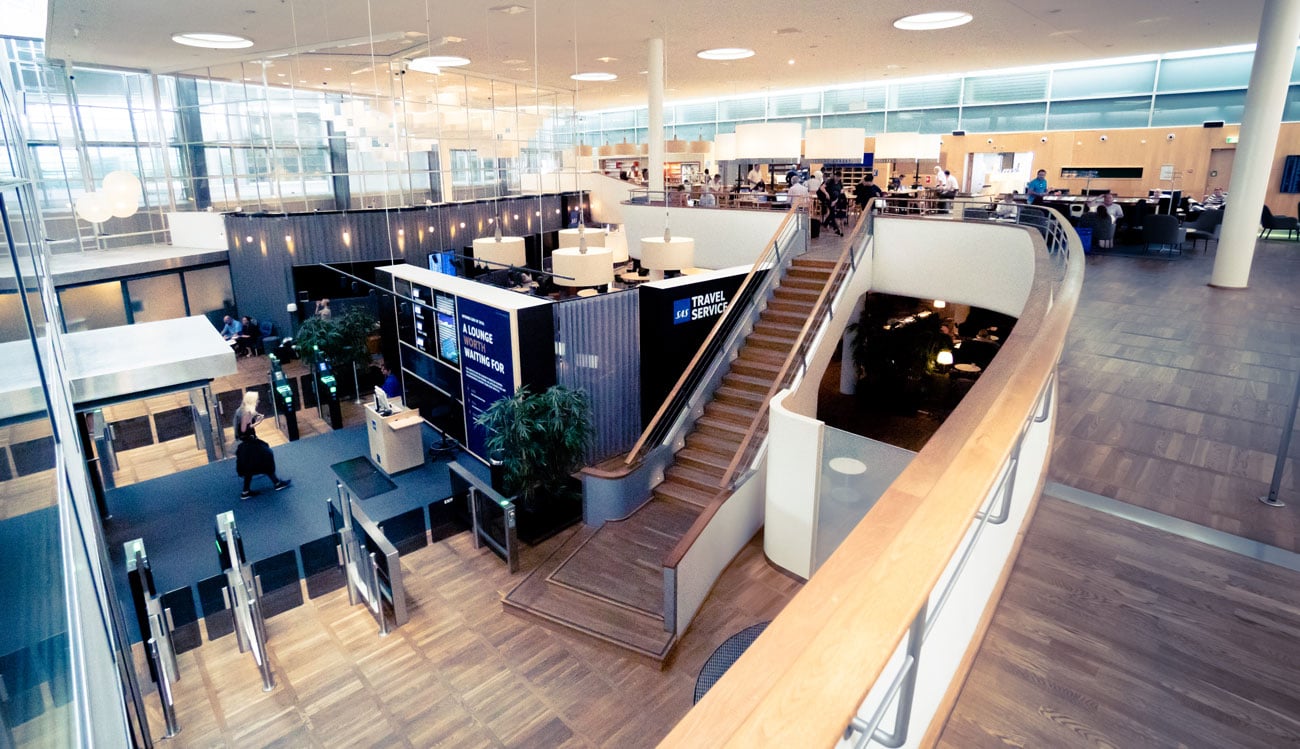 airport lounge with large staircase and dark wooden floors