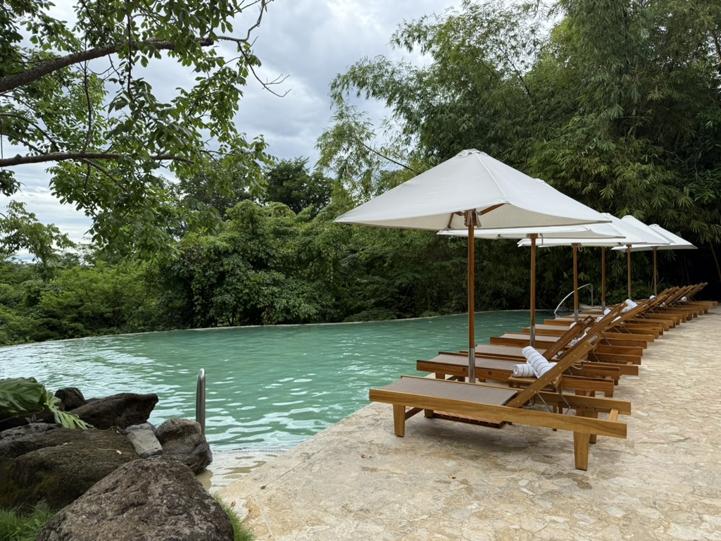 Lounge chairs and umbrellas by a pool