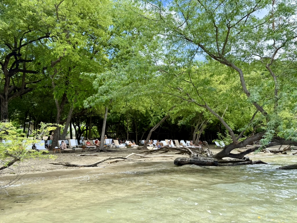 Lounge chairs on the sand at the private beach club at Andaz Peninsula Papagayo
