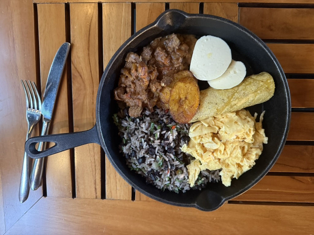 Costa Rican breakfast bowl on a table with fork and knife