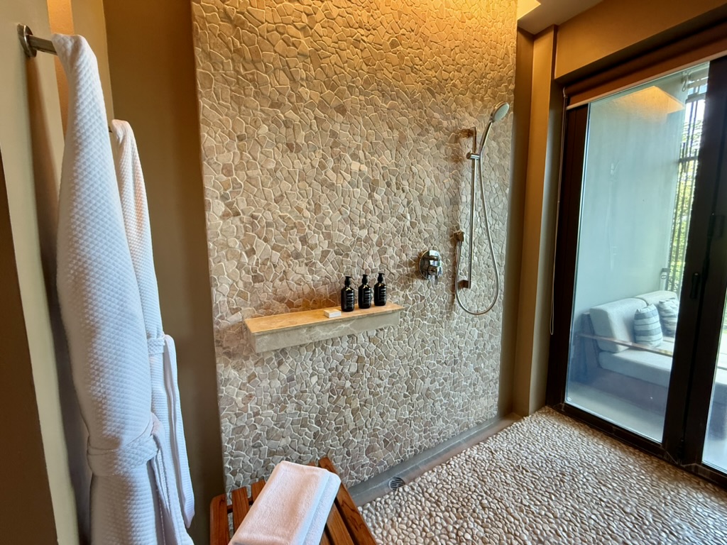 Walk-in, stone-tiled shower at the Andaz Peninsula Papagayo