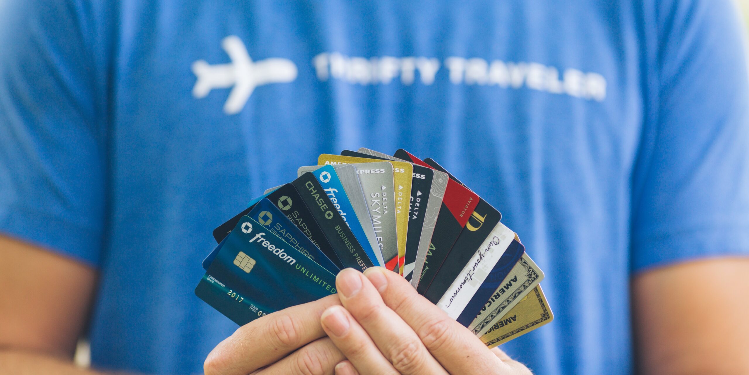 man holding many different credit cards