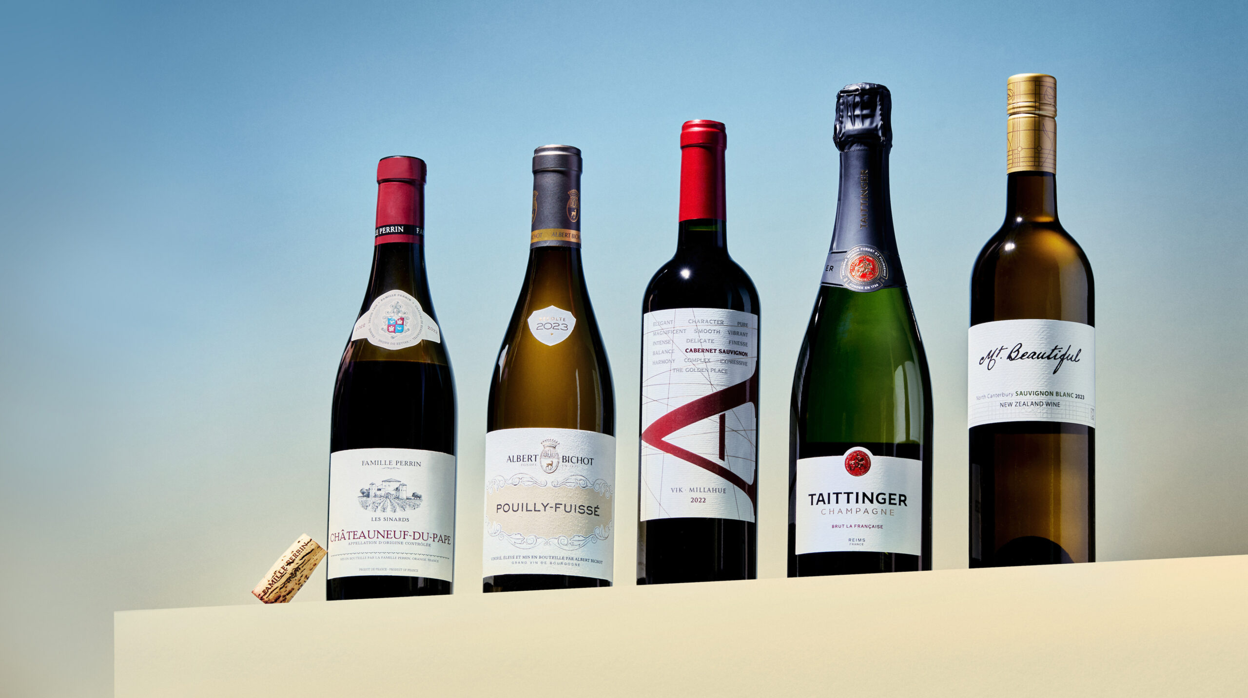 Five bottles of wine on a ledge