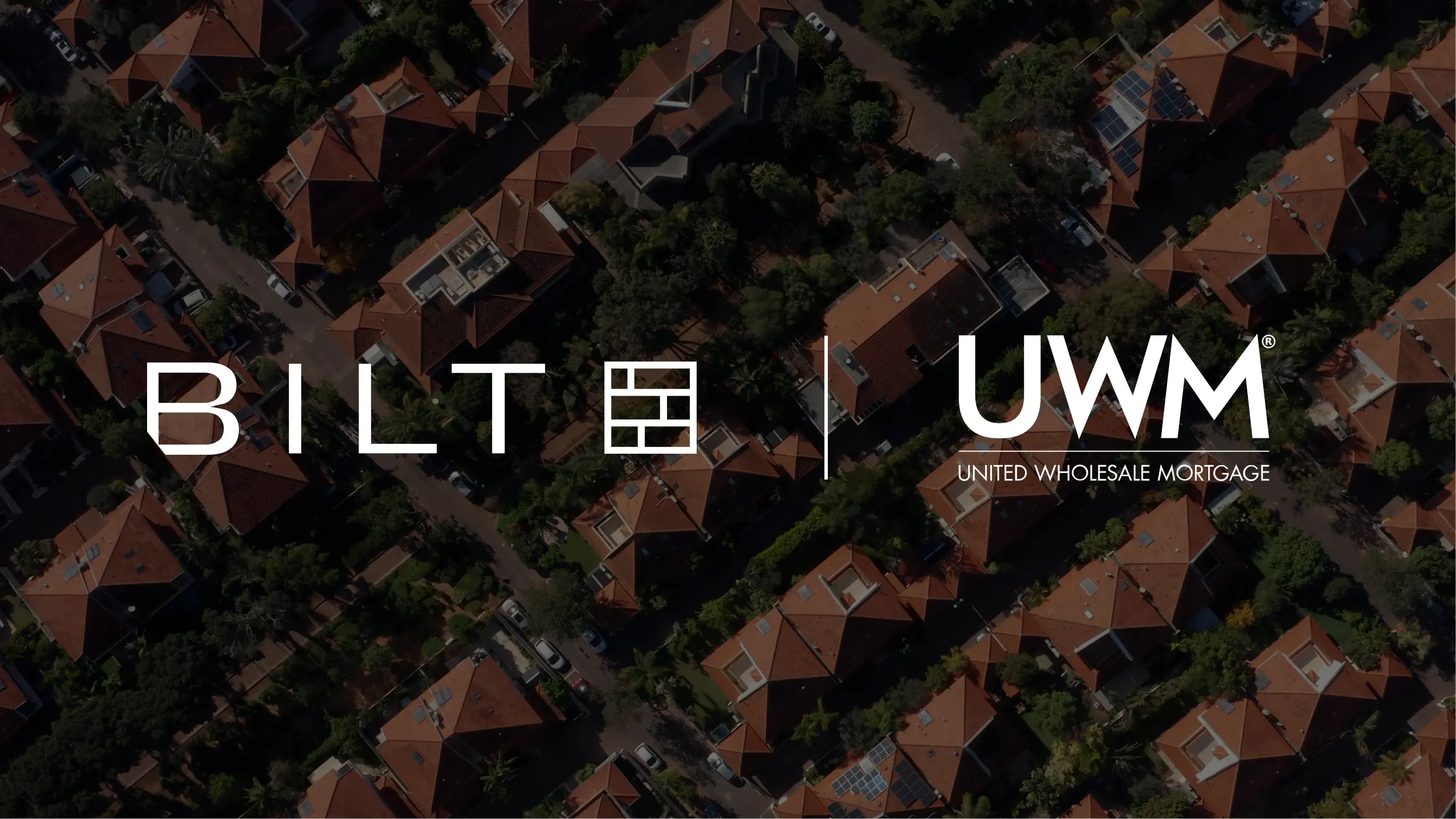 Bilt and united wholesale mortgage logo on top of an aerial shot of houses
