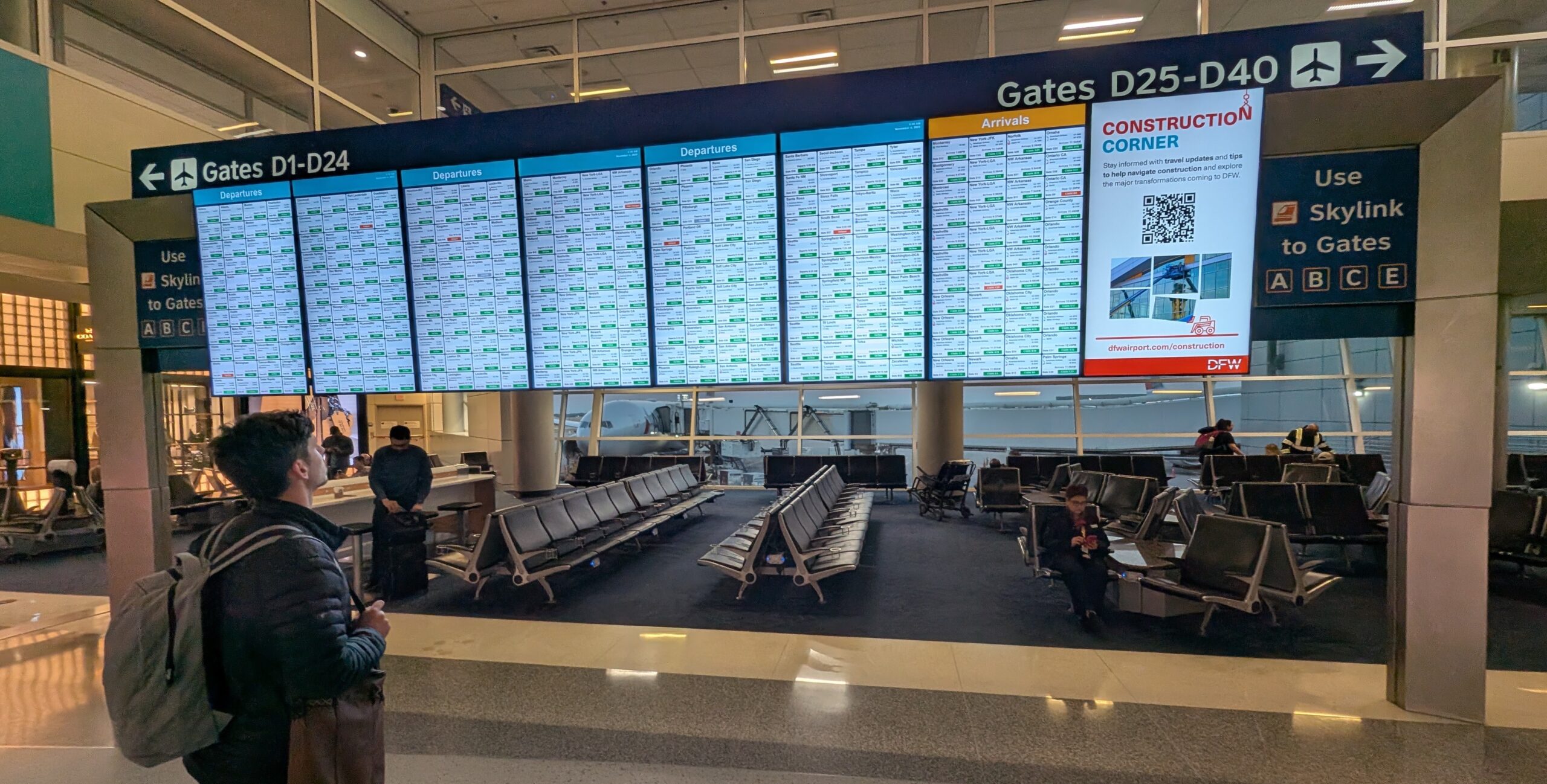 Heading to Mexico Soon? The Latest on Travel After Violence in Puerto Vallarta 2 A man standing in an airport terminal looking at the flight departure board.