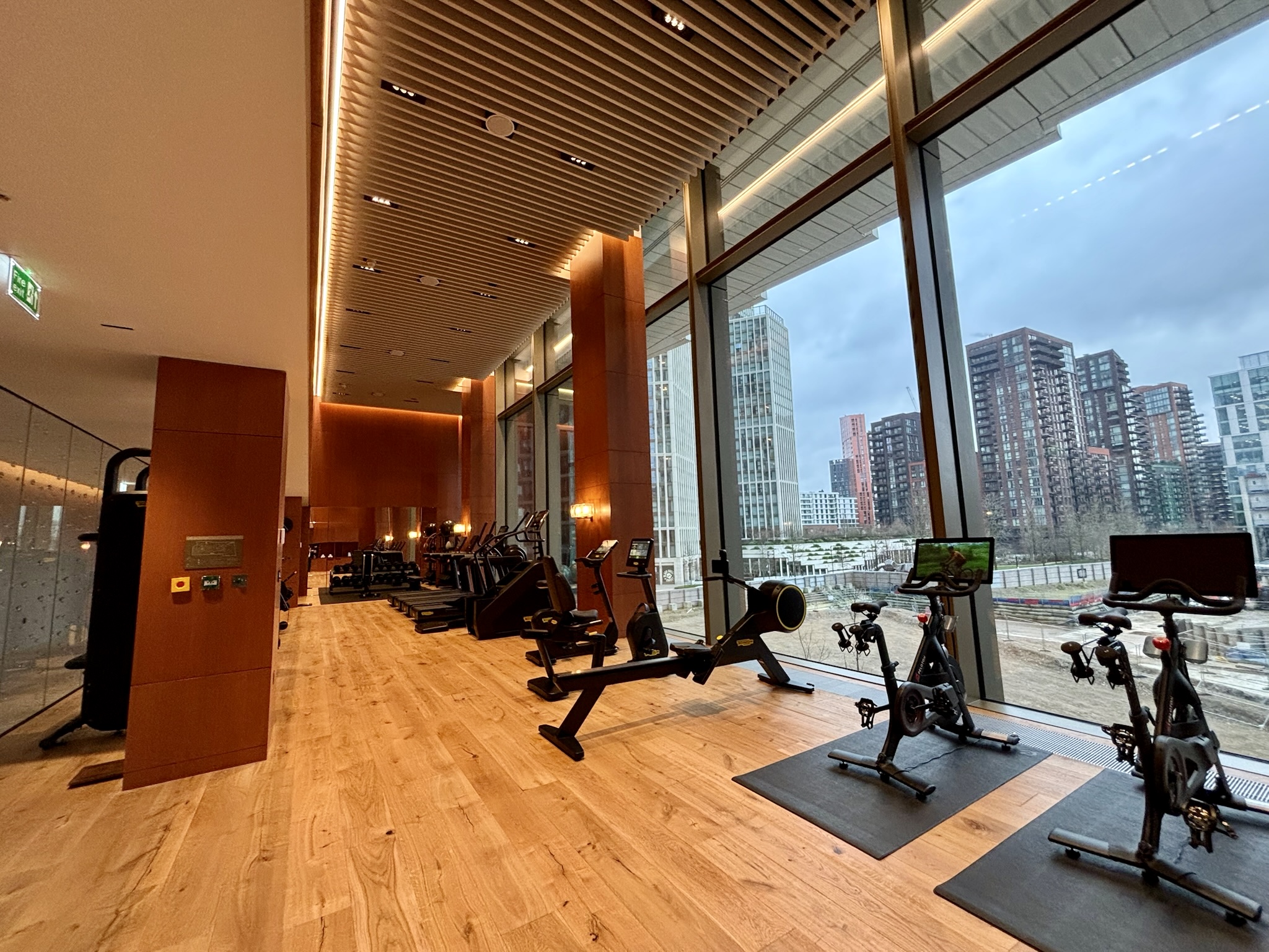 Inside the Park Hyatt London River Thames: Rooms, Dining, Pool & More 39 Gym with cardio equipment and windows overlooking the city