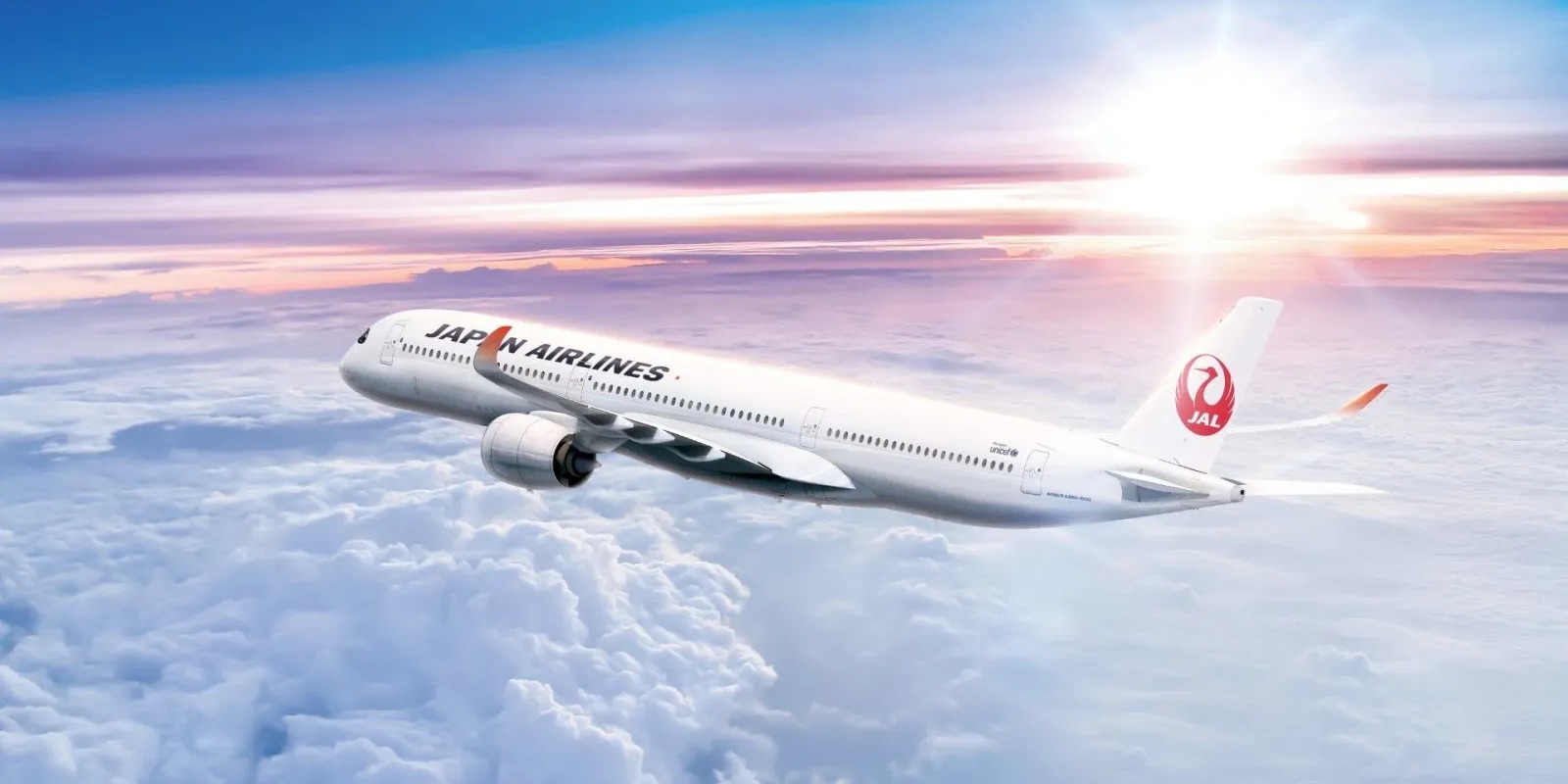 Japan Airlines A350-1000 flying above the clouds with the sun shining in the background