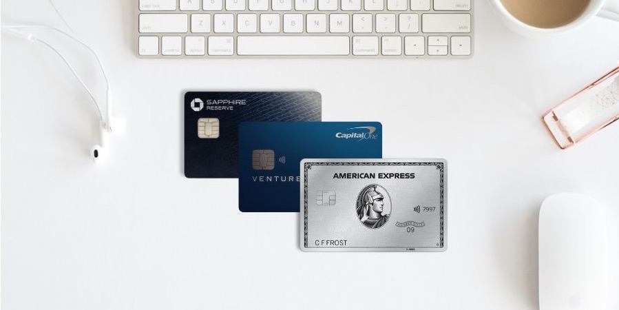 Chase Sapphire Reserve, Capital One Venture X, and Amex Platinum Cards with a keyboard, mouse, and cup of coffee