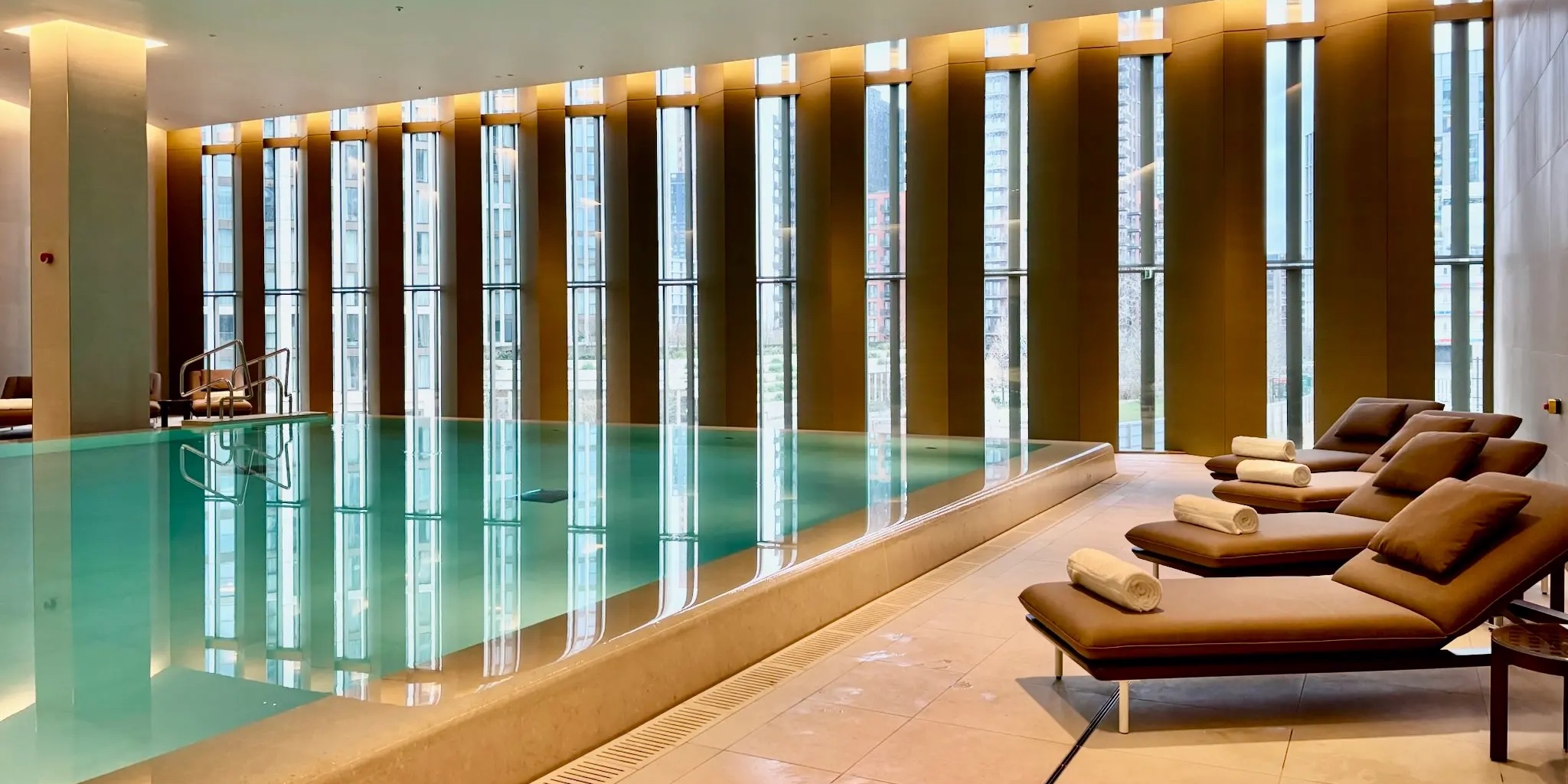 Park Hyatt London River Thames Pool with lounge chairs and windows letting in natural light.