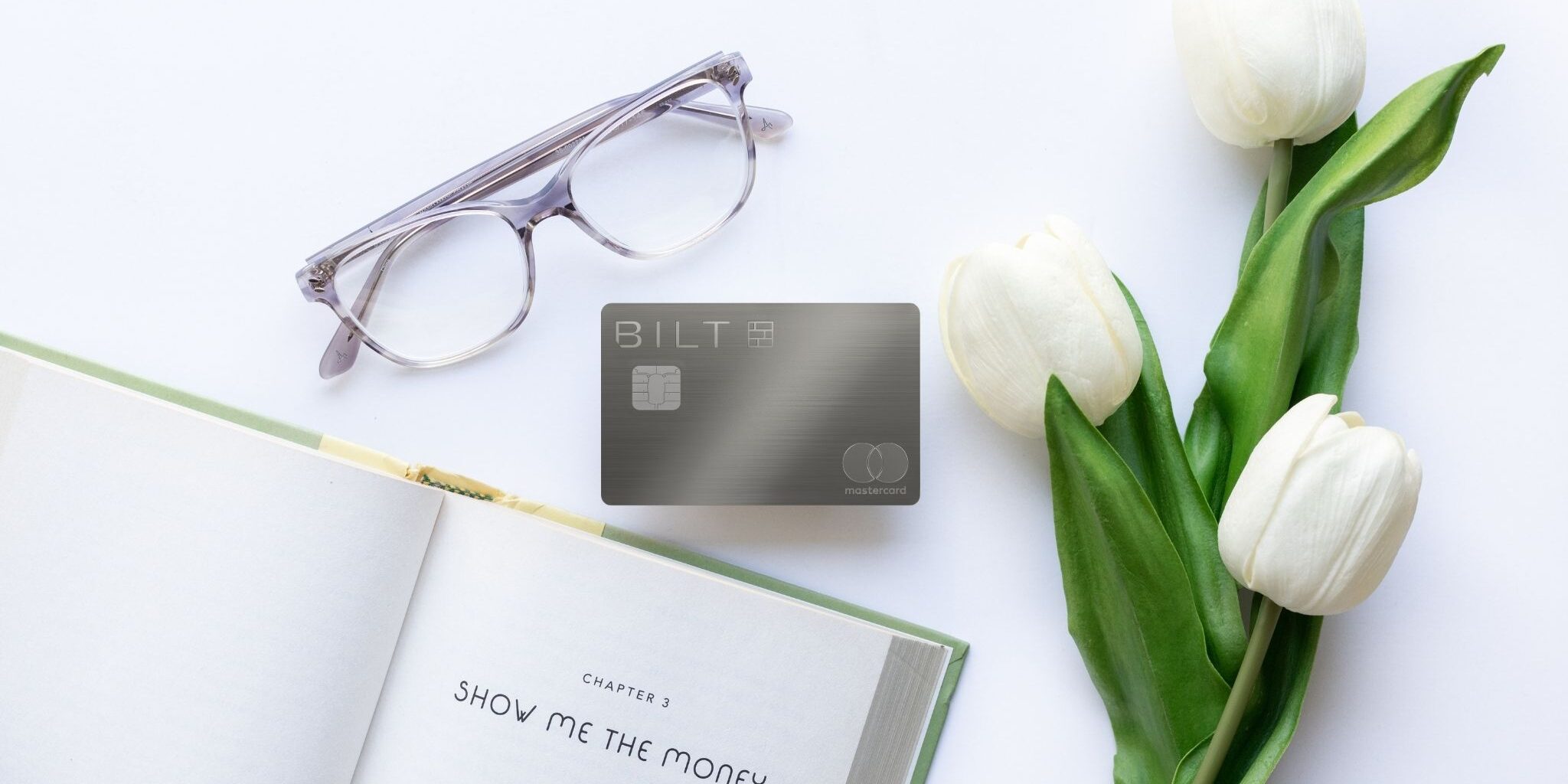 From No Thanks to No-Brainer: Why I Pulled a U-Turn on the Bilt Palladium Card 3 Bilt Palladium Card with glasses, roses, and an open book.