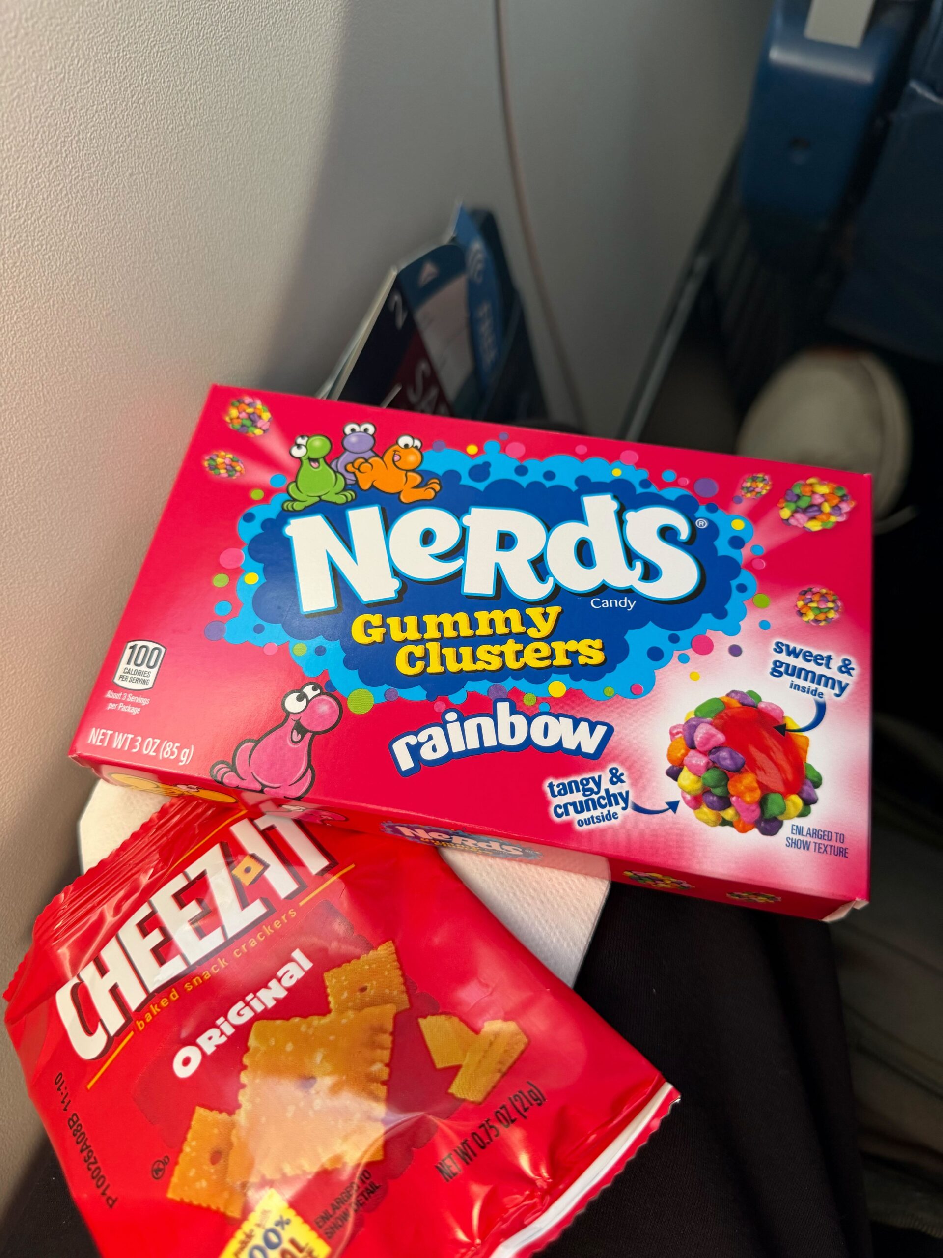 A Little-Known & Tasty Benefit of Delta SkyMiles Cards: Get a Free Premium Snack! 2 nerds gummy clusters next to a small bag of cheez its