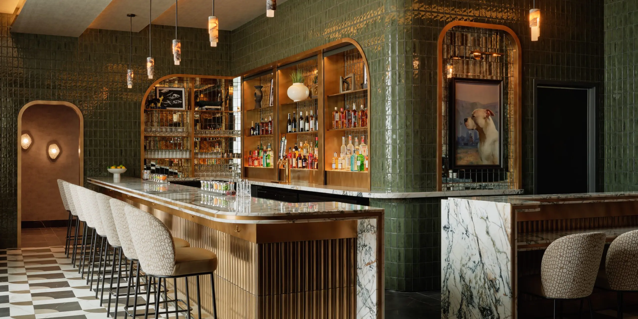 Barstools and countertop with green walls at the Sidecar by Centurion Lounge LAS.