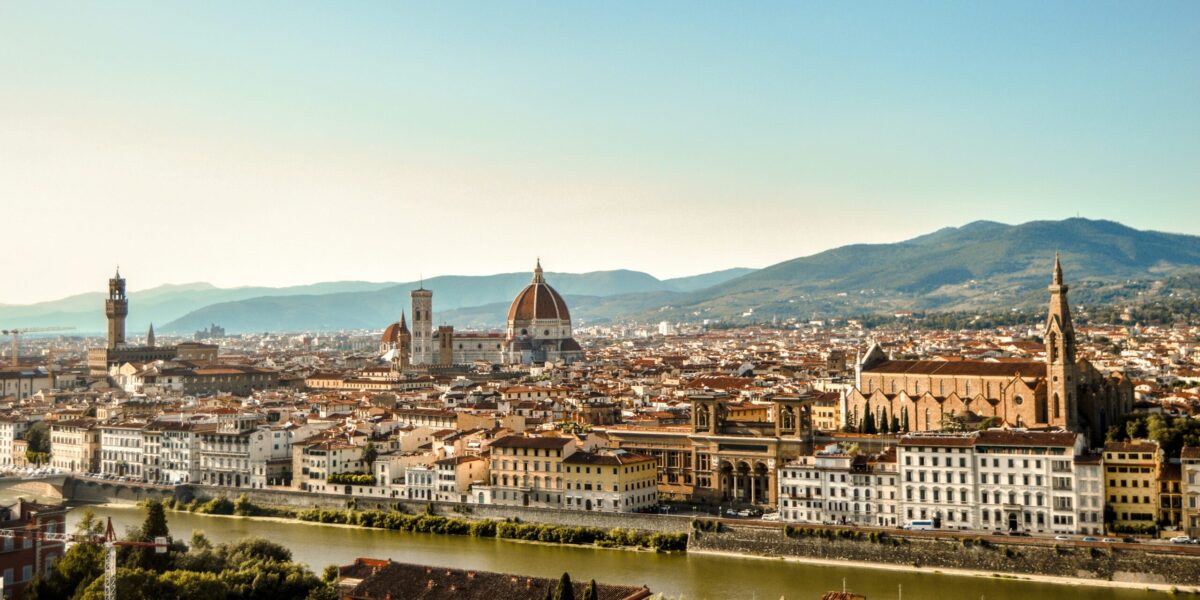 skyline of florence with many buildings and mountains in the background