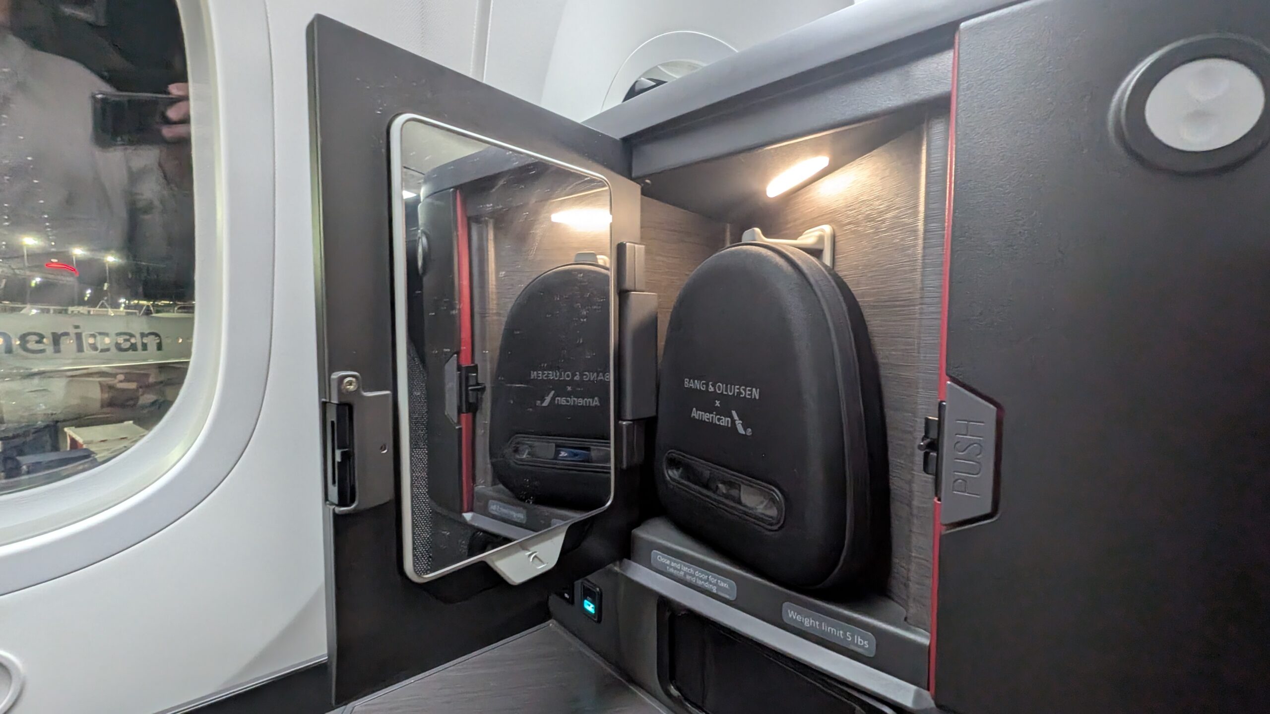 American Airlines' New Flagship Suite Review: A Stellar Hop Across the Pond 30 AA Flagship Suite: Storage compartment with headphones and a mirror