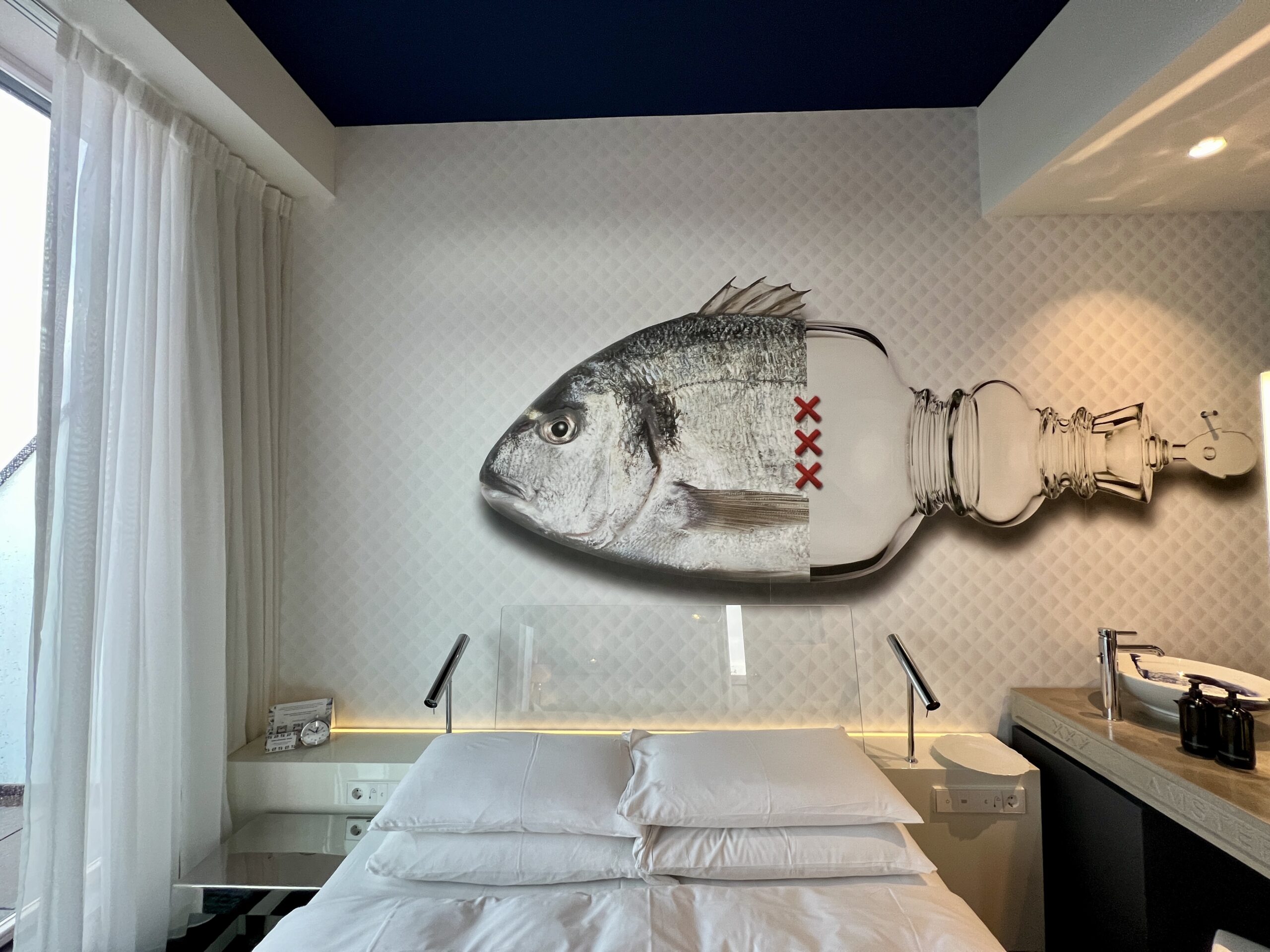 The Biggest Winners & Losers in Hyatt's Brutal Devaluation 4 andaz amsterdam hotel bed with fish over bed