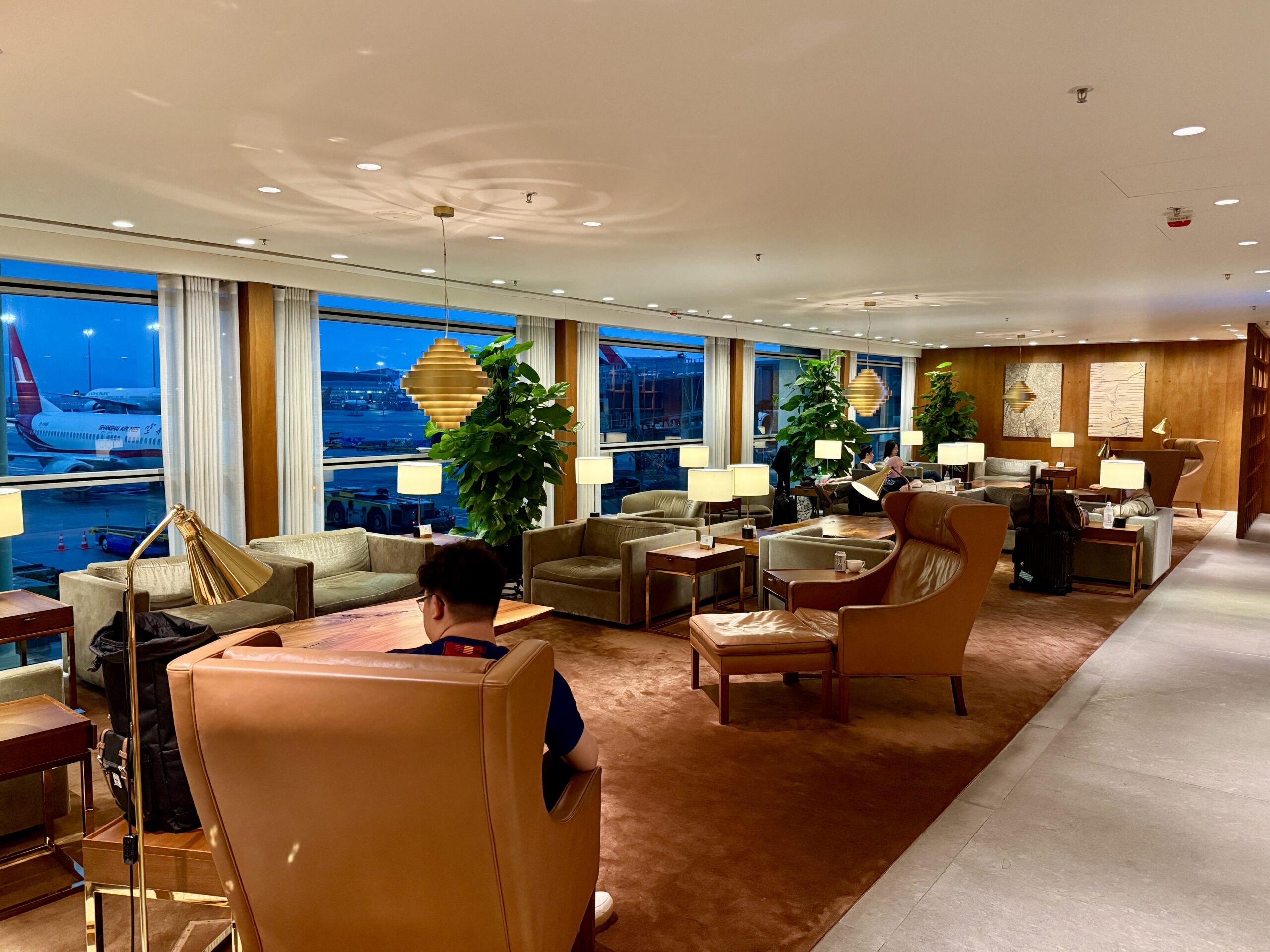 Aging Like a Fine Wine: Cathay Pacific First Class 777 Review 4 seating area with planes in background