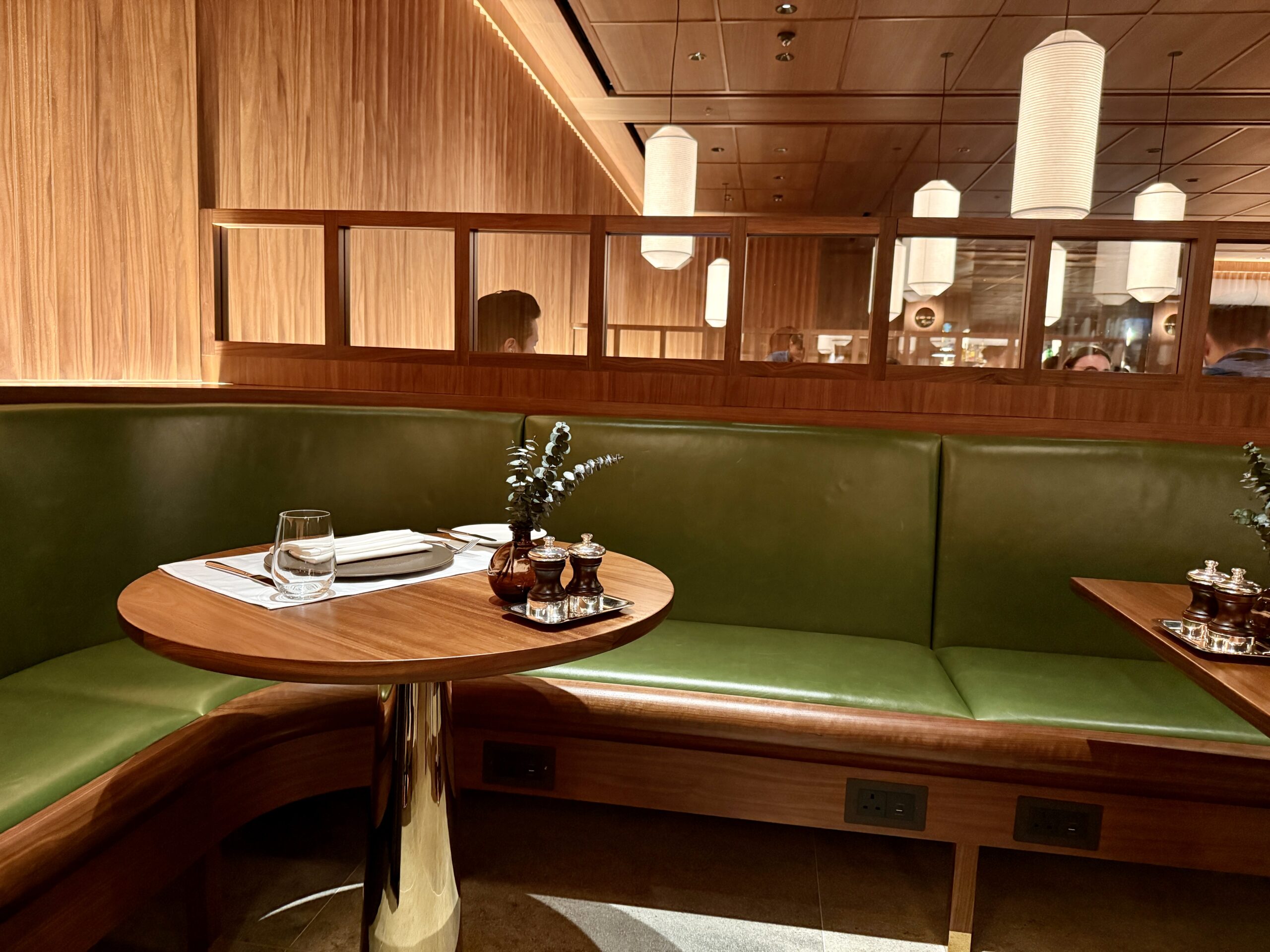 Aging Like a Fine Wine: Cathay Pacific First Class 777 Review 7 dining table with green couch