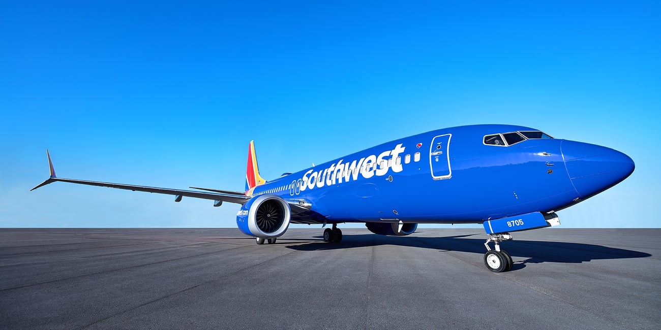 southwest plane sitting on tarmac with blue sky