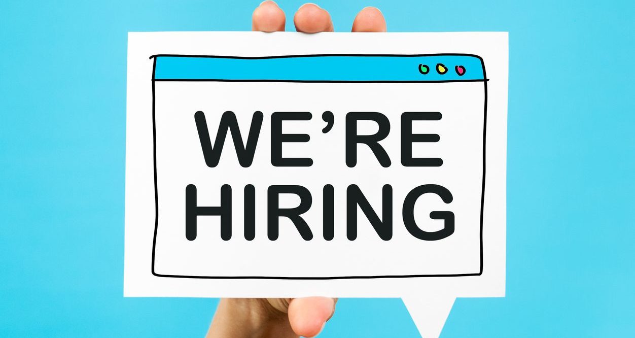 The Extra Mile, June 30: Airport Security is Glowing Up, Last Chance Transfer Bonus & More 7 we're hiring held up by a hand on a light blue screen