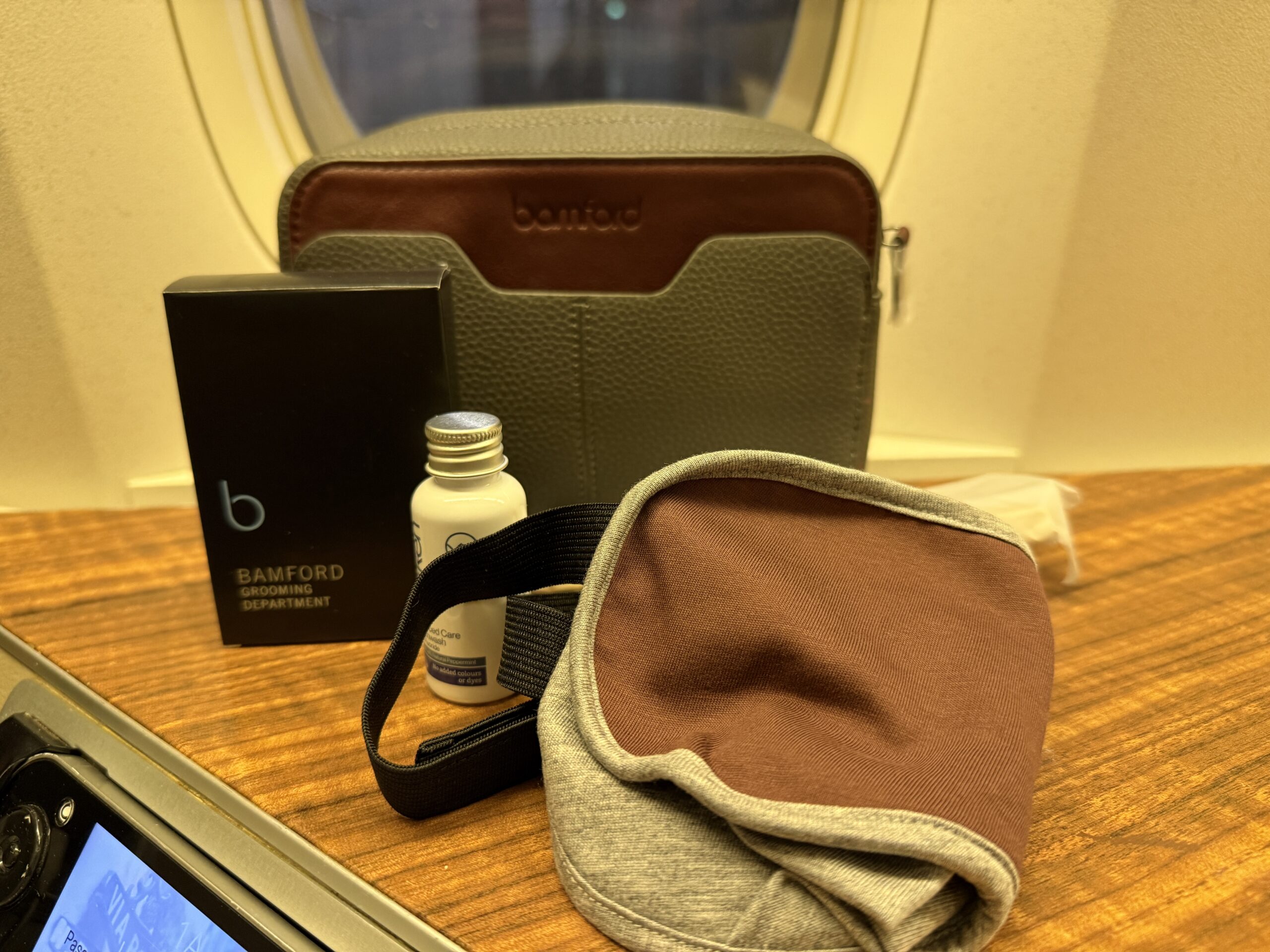 Aging Like a Fine Wine: Cathay Pacific First Class 777 Review 25 bamford bag with amenity kit contents on woodgrain counter