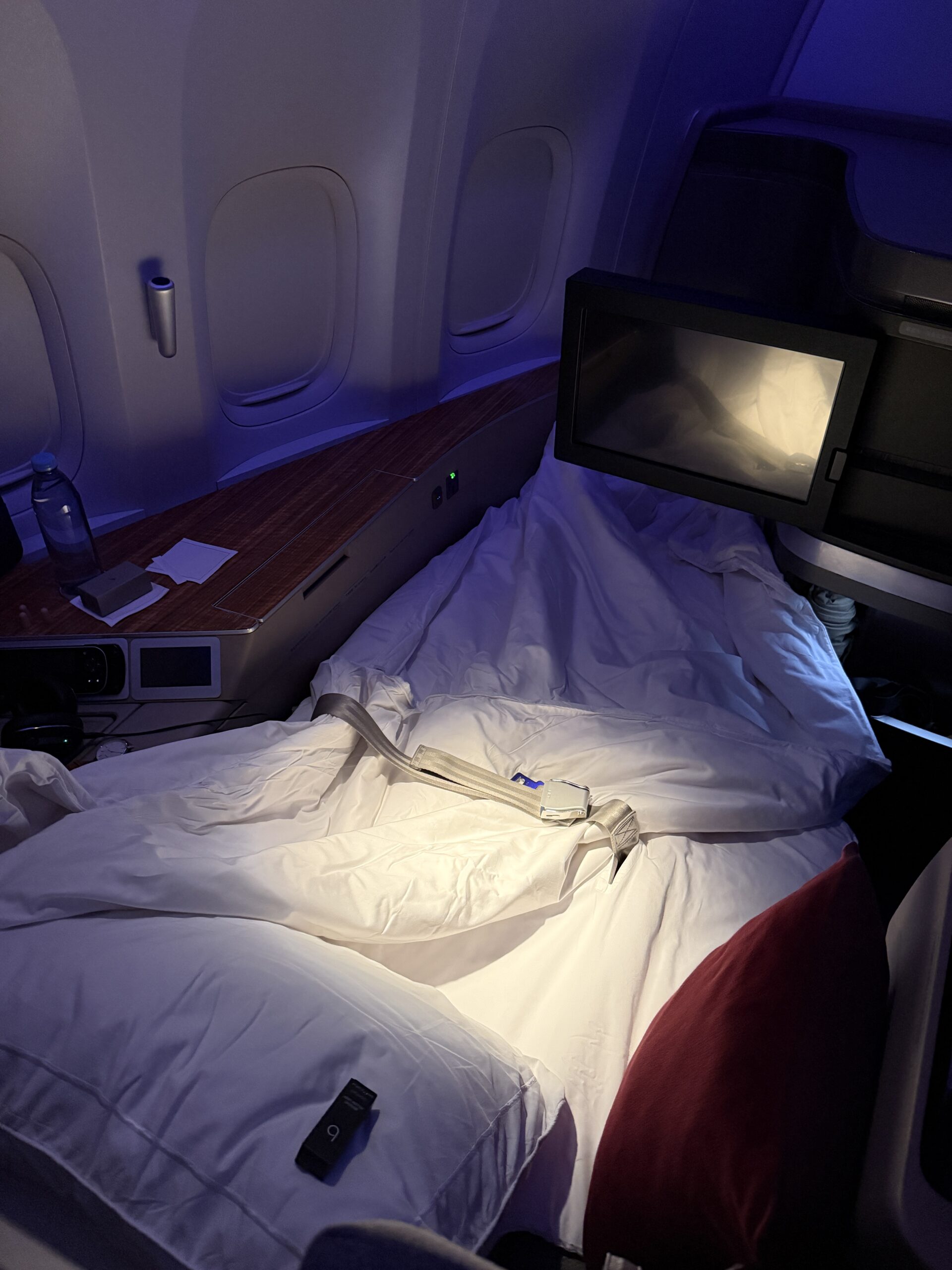 Aging Like a Fine Wine: Cathay Pacific First Class 777 Review 27 large bed on plane with screen