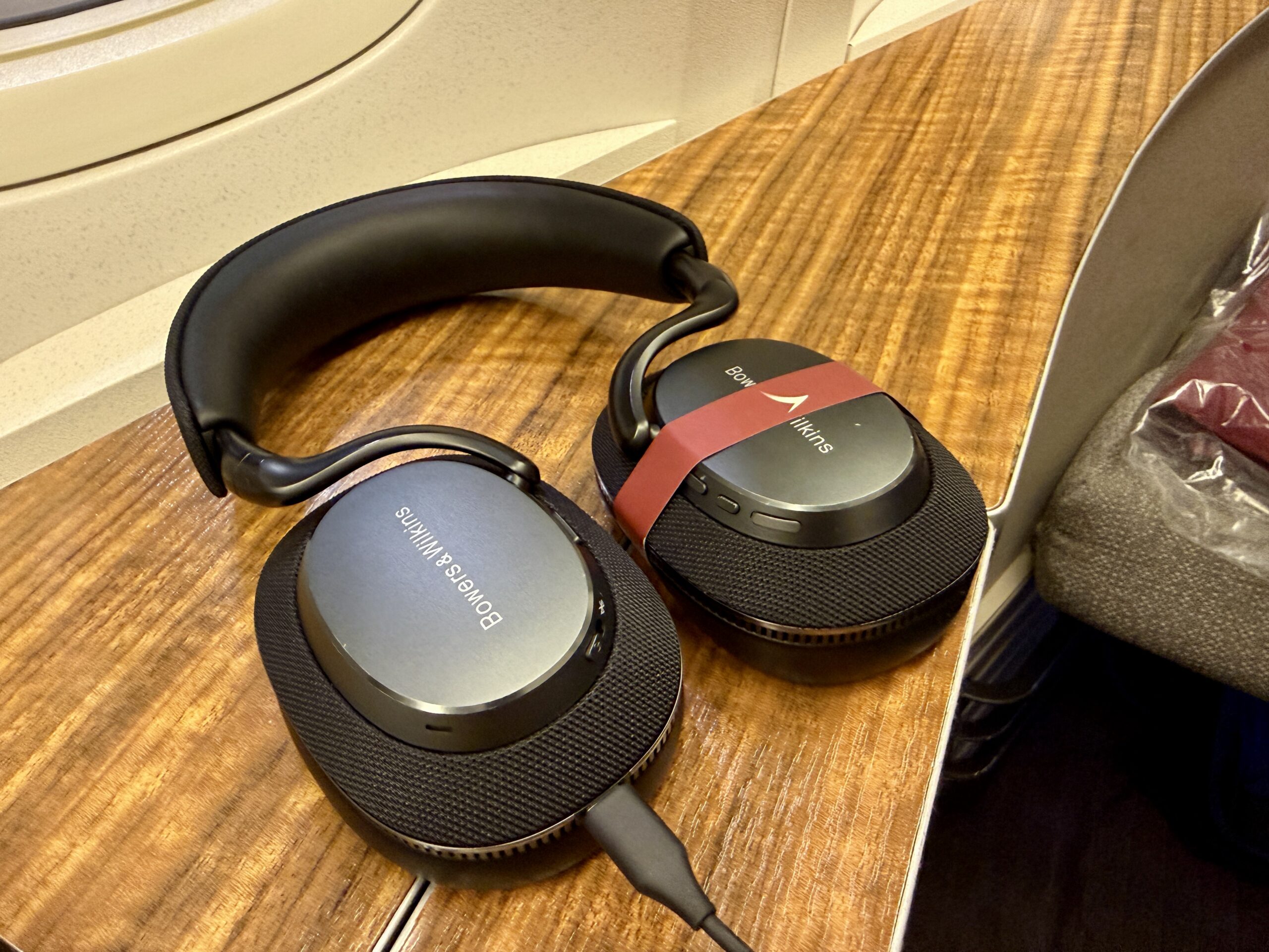 Aging Like a Fine Wine: Cathay Pacific First Class 777 Review 26 bowers & wilkins headphones resting on woodgrain counter