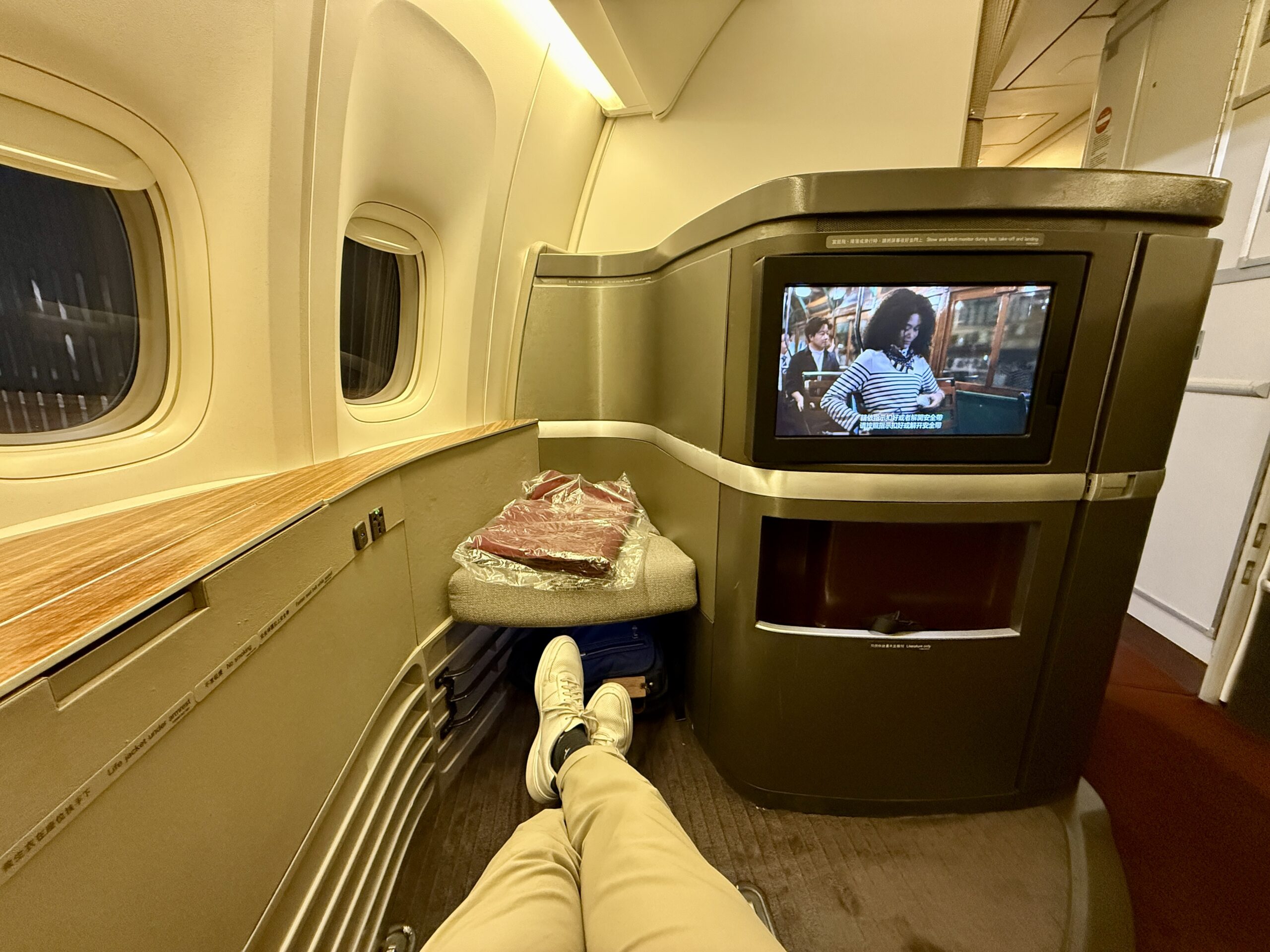Aging Like a Fine Wine: Cathay Pacific First Class 777 Review 17 legs outstretched in first class seat