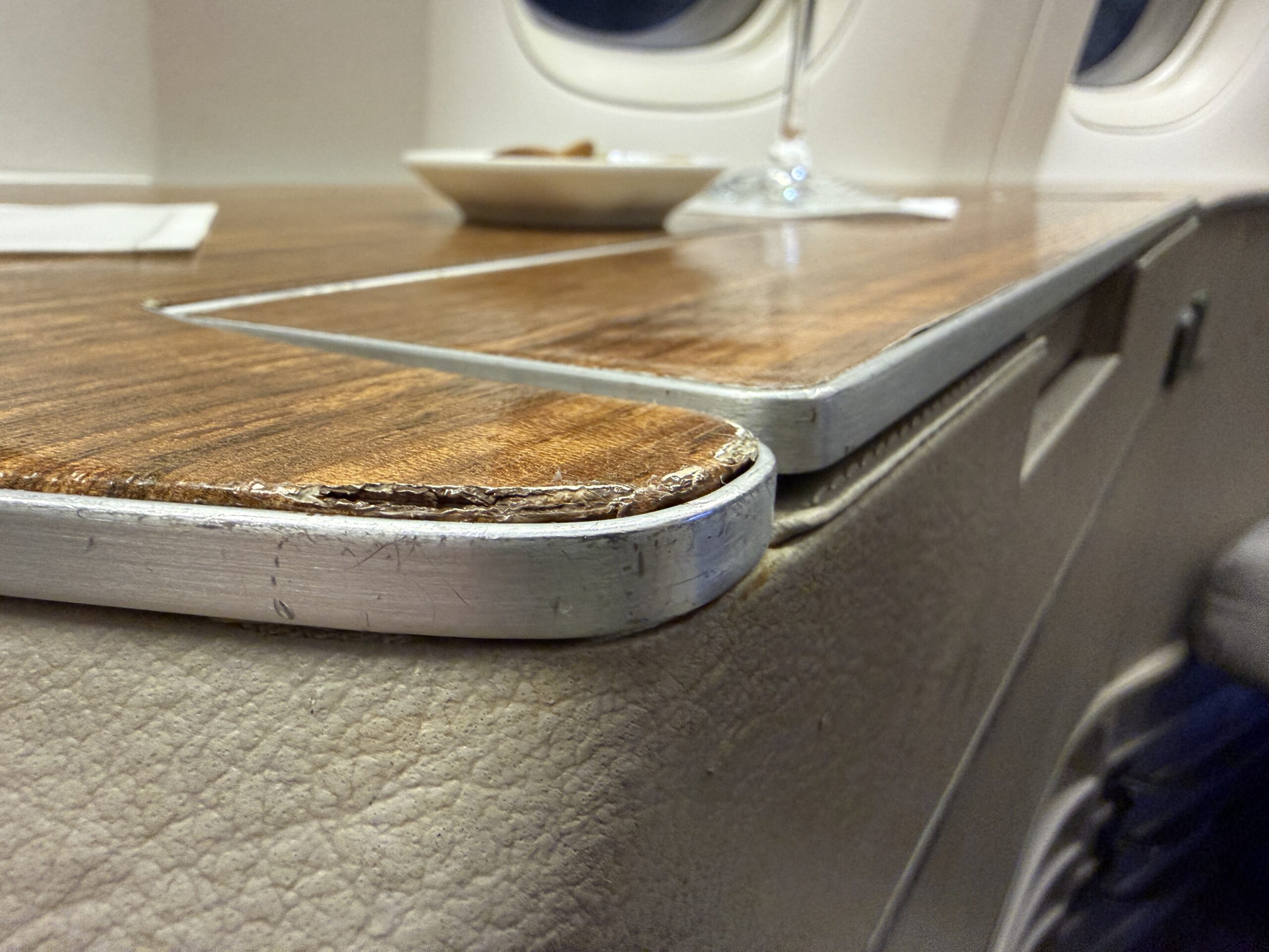 Aging Like a Fine Wine: Cathay Pacific First Class 777 Review 21 seat details showing large gashes in woodgrain