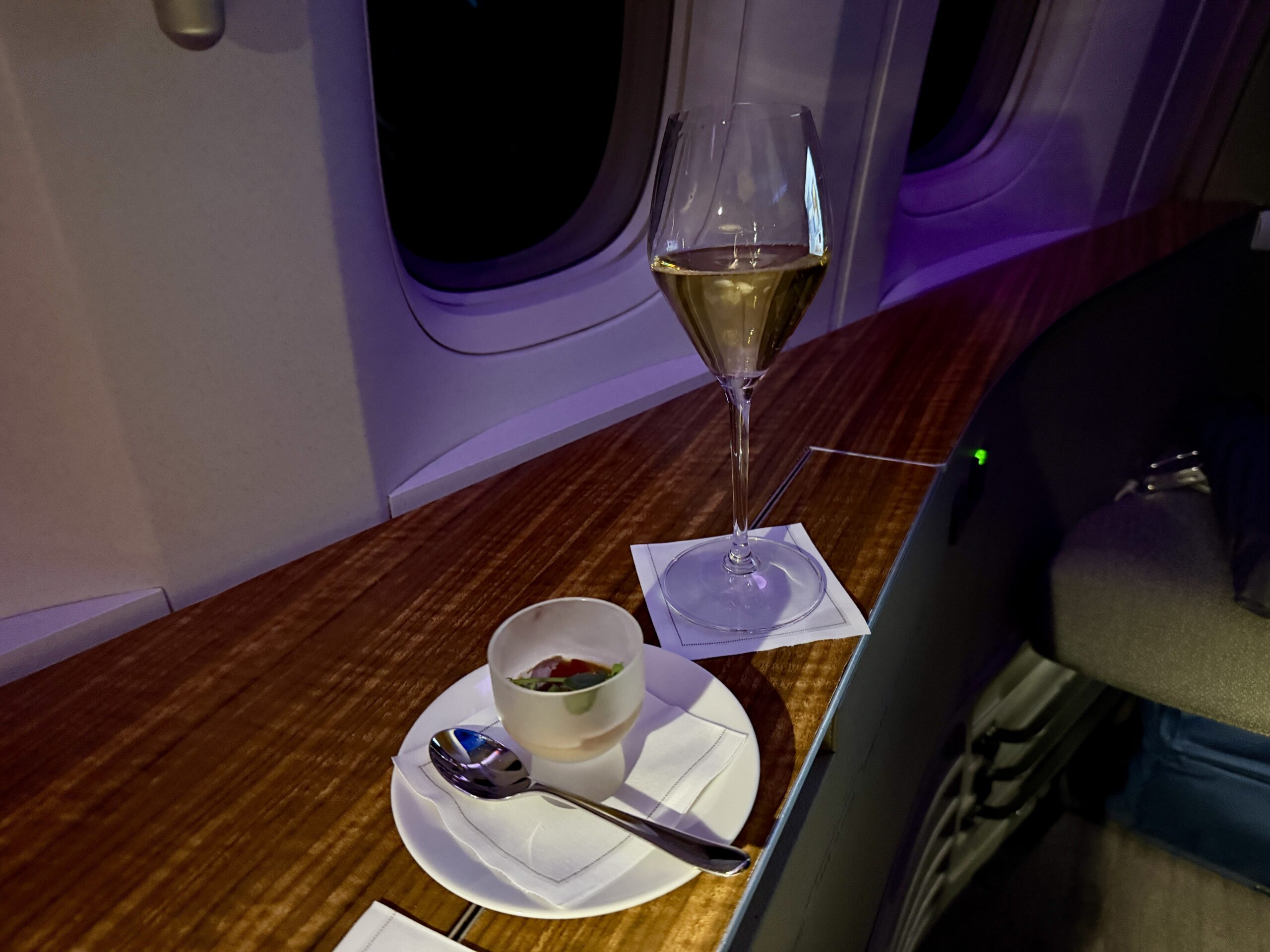 Aging Like a Fine Wine: Cathay Pacific First Class 777 Review 30 small circular dish with spoon and glass of champagne