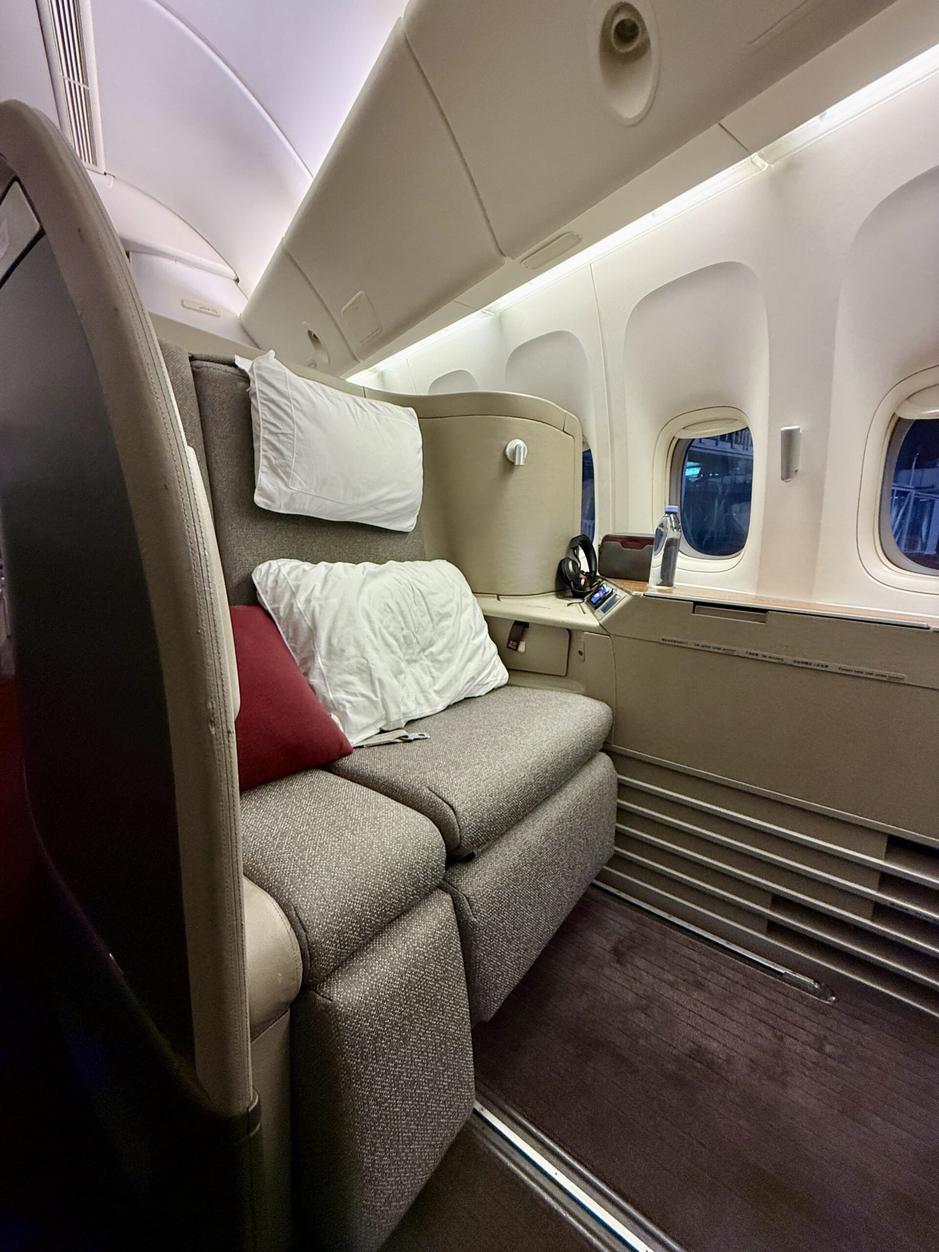 Aging Like a Fine Wine: Cathay Pacific First Class 777 Review 16 vertical photo of first class plane seat