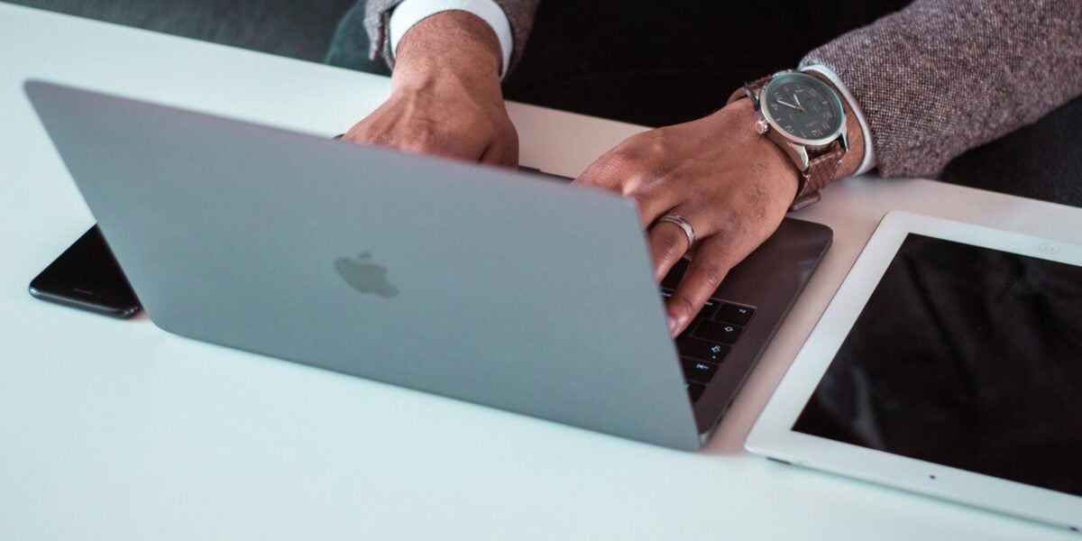 The Extra Mile, July 20: Revisiting an Old Hot Take, Emirates 'Game-Changing' Headrest & More 1 A person using a macbook with phone and ipad nearby
