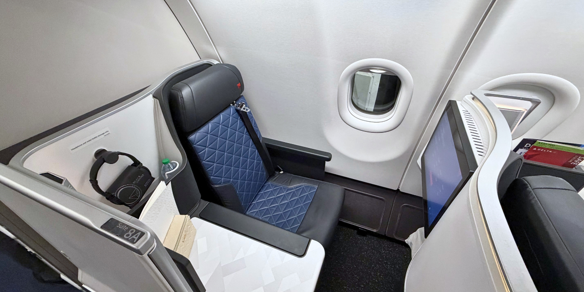 The Extra Mile, July 2: When Lie-Flat Seats Aren't Worth It, A Rare Transfer Bonus & New Routes to Watch 2 a delta one suite business class seat up against a plain gray plane wall